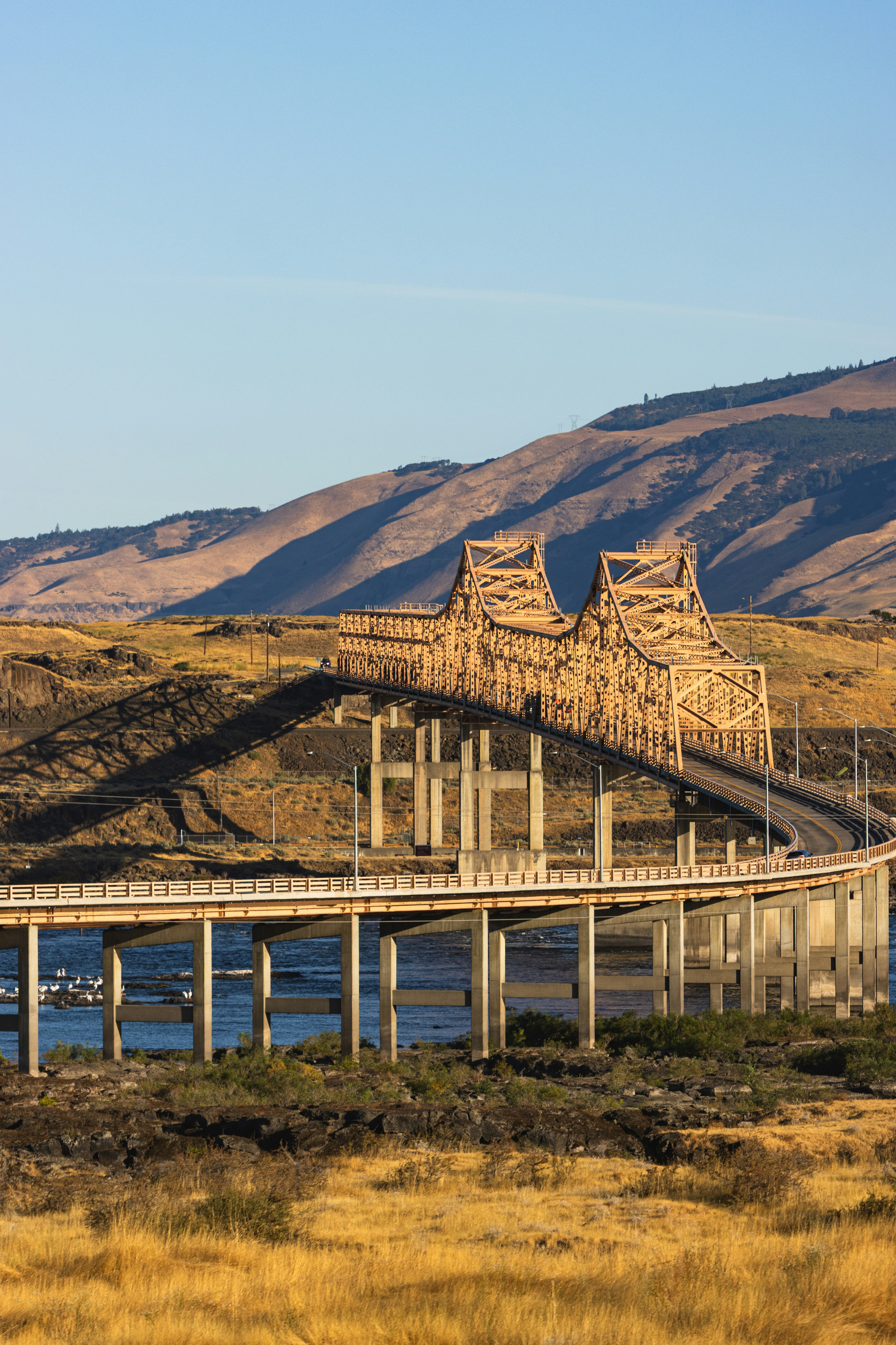 A large metal bridge spans a body of water.