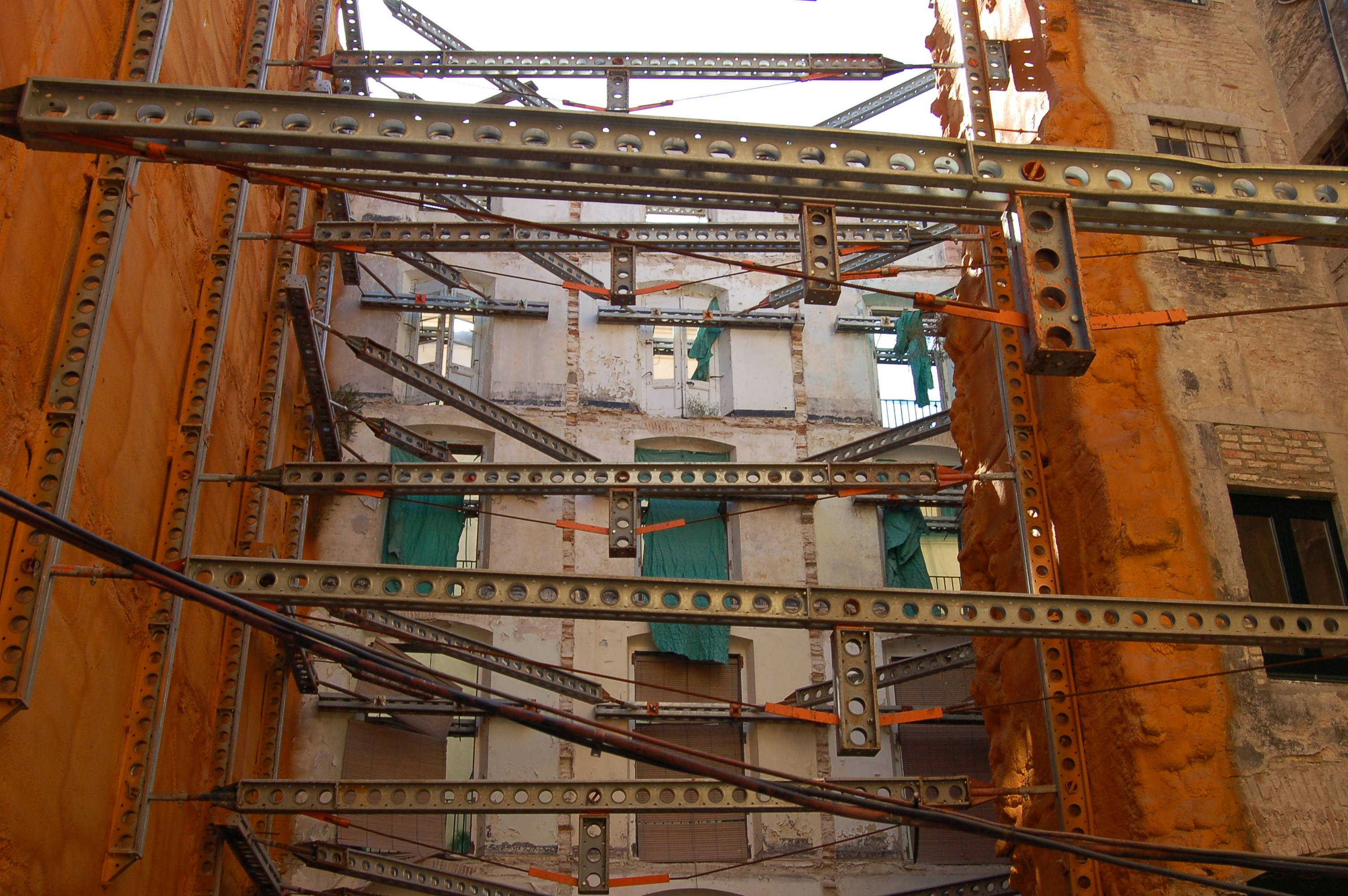 Building undergoing structural reinforcement with metal beams.