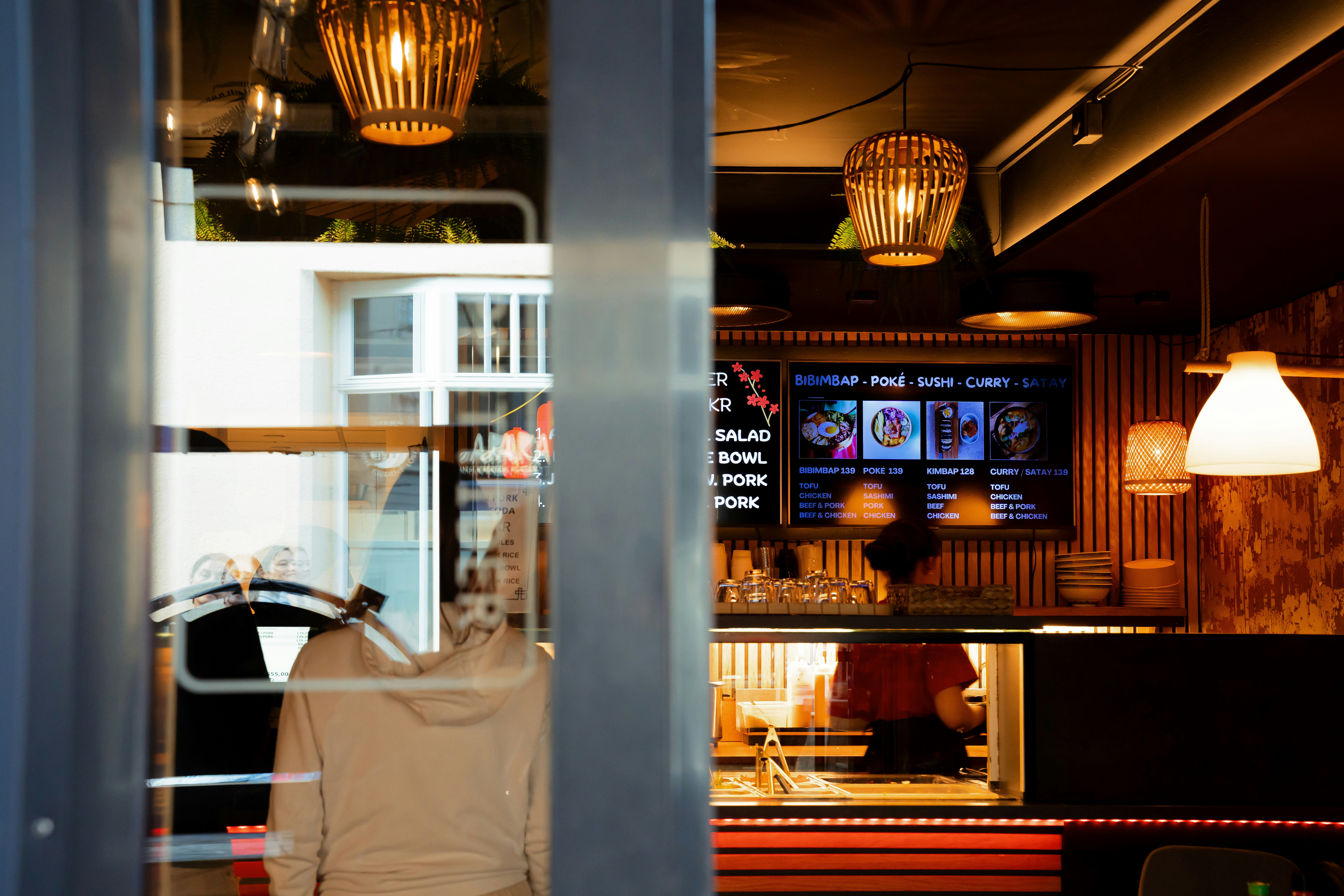 Interior of a cafe with warm lighting and menu board