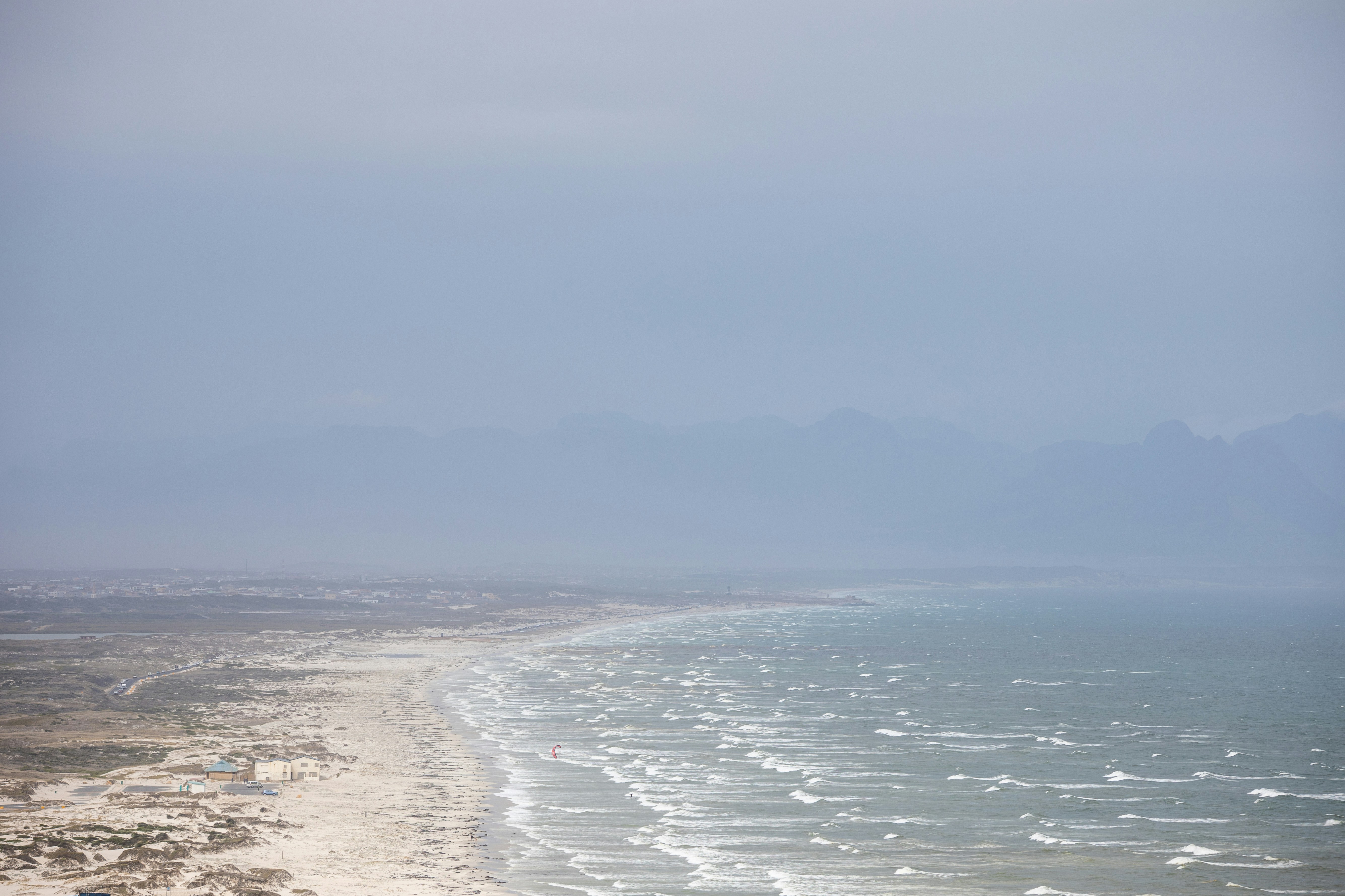 A wide view of a sandy beach and the ocean