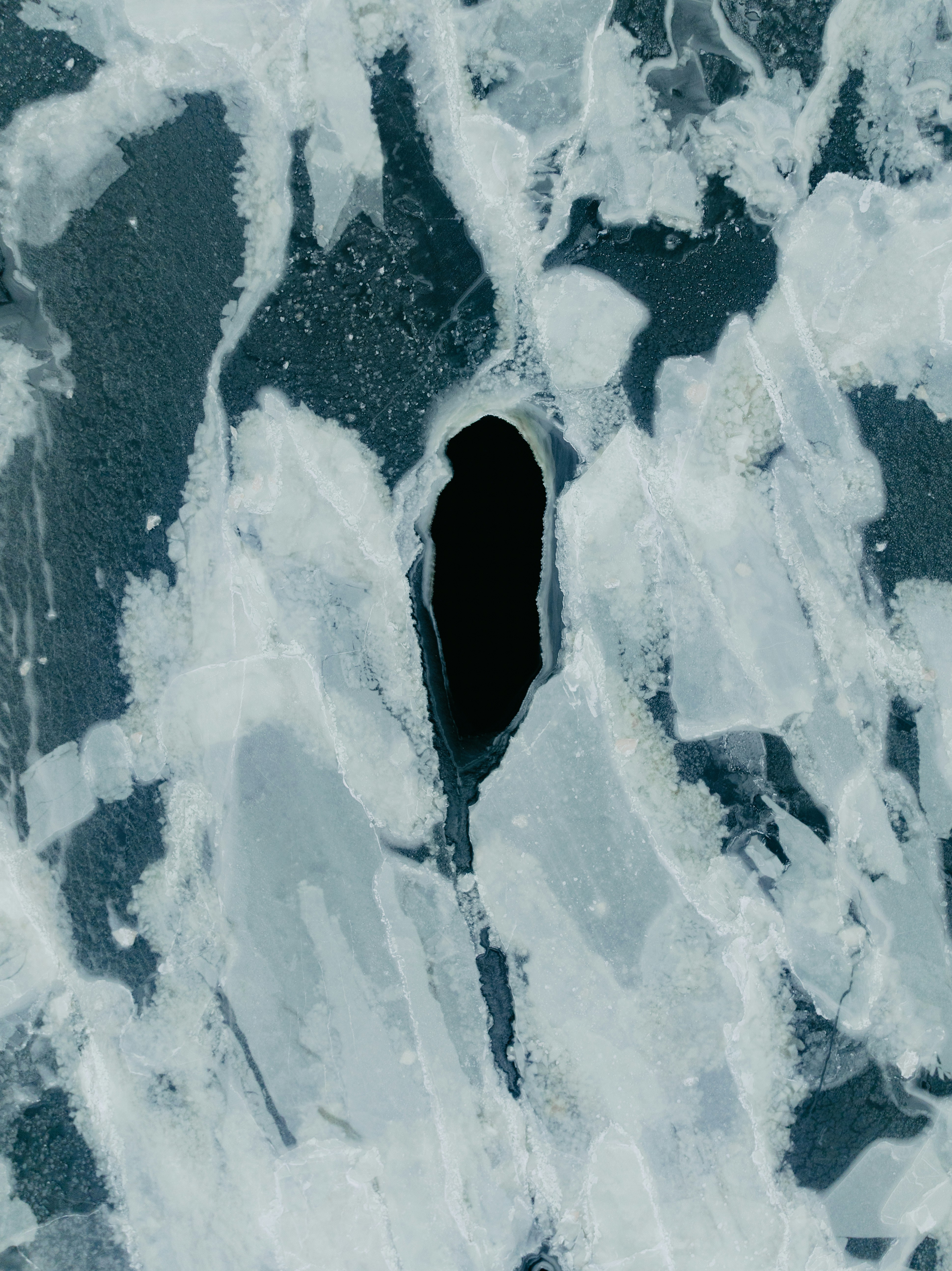 Cracked ice with a dark hole in the center