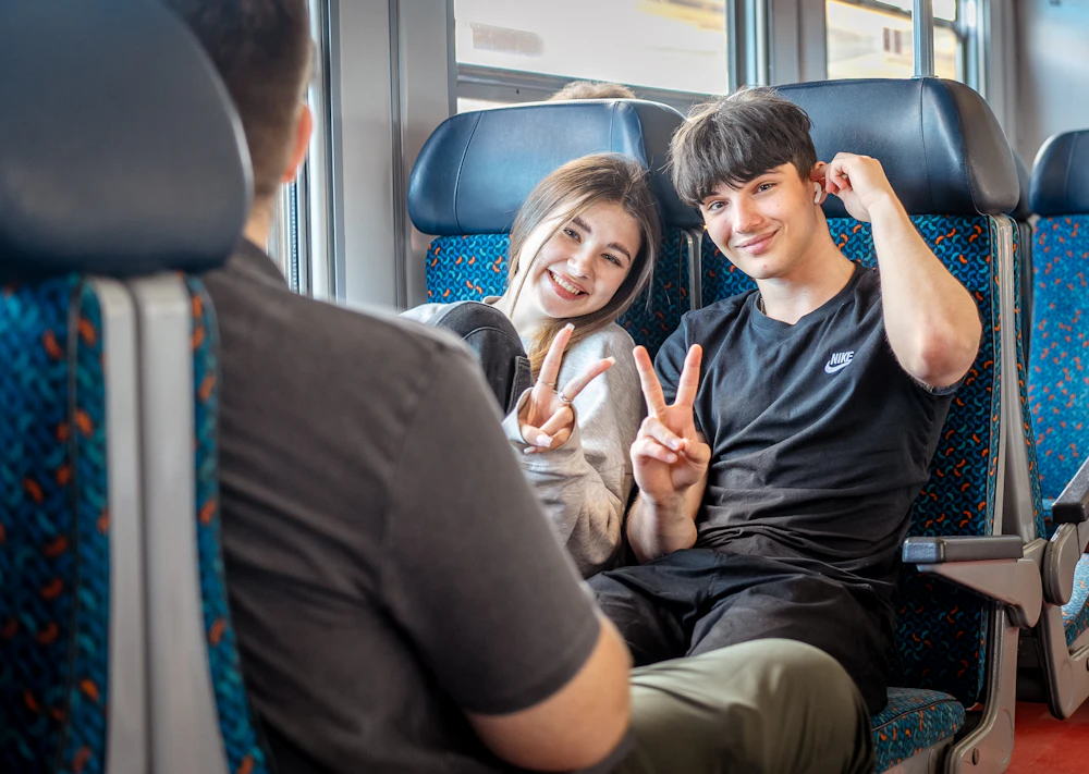 Passengers relaxing on a clean, comfortable train