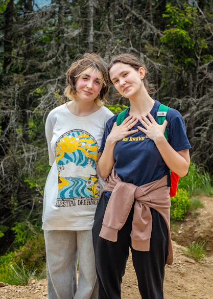 Two young women posing in a forest