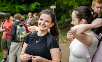Young woman smiling with friends on a hike