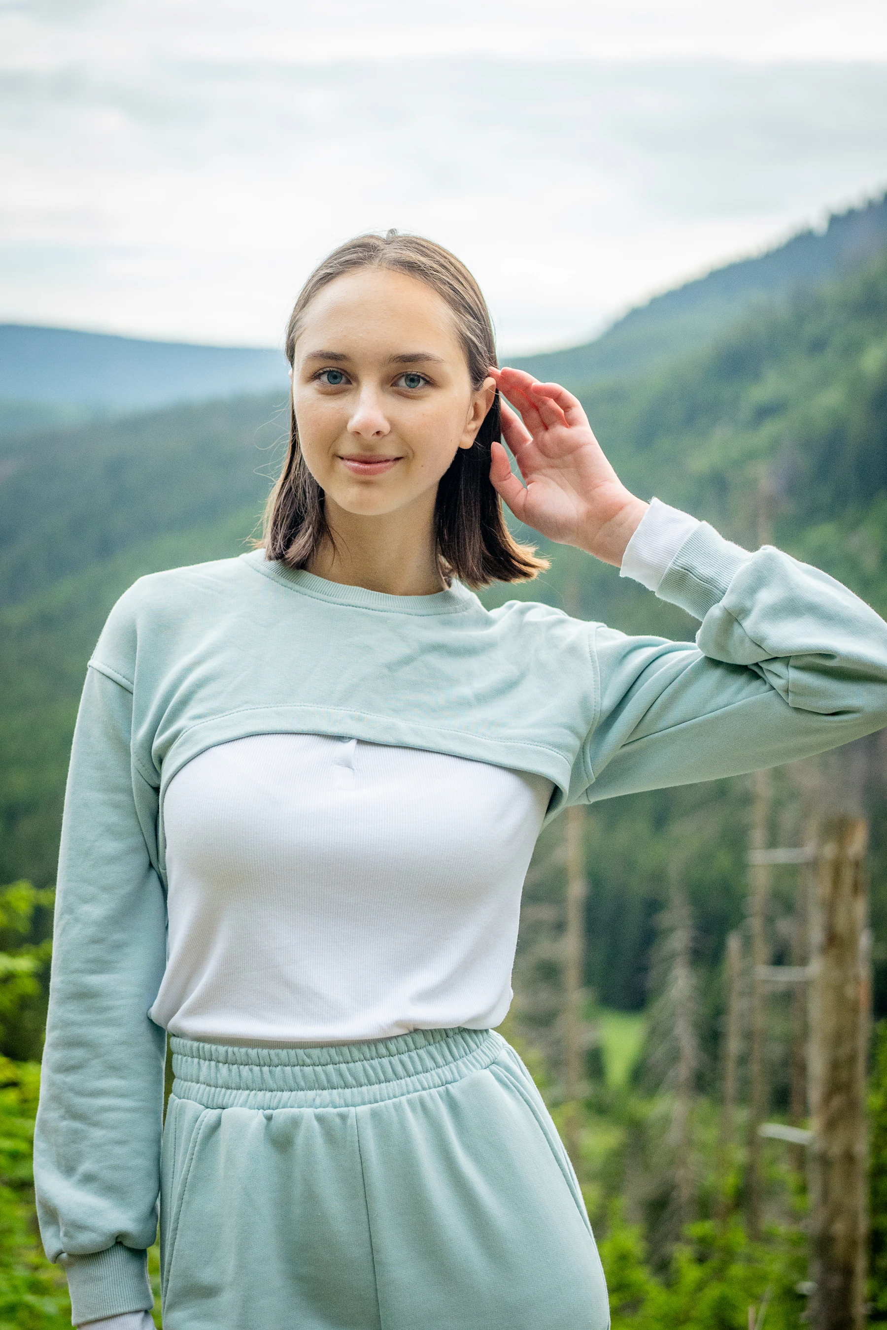 Woman in sportswear moving through an outdoor landscape