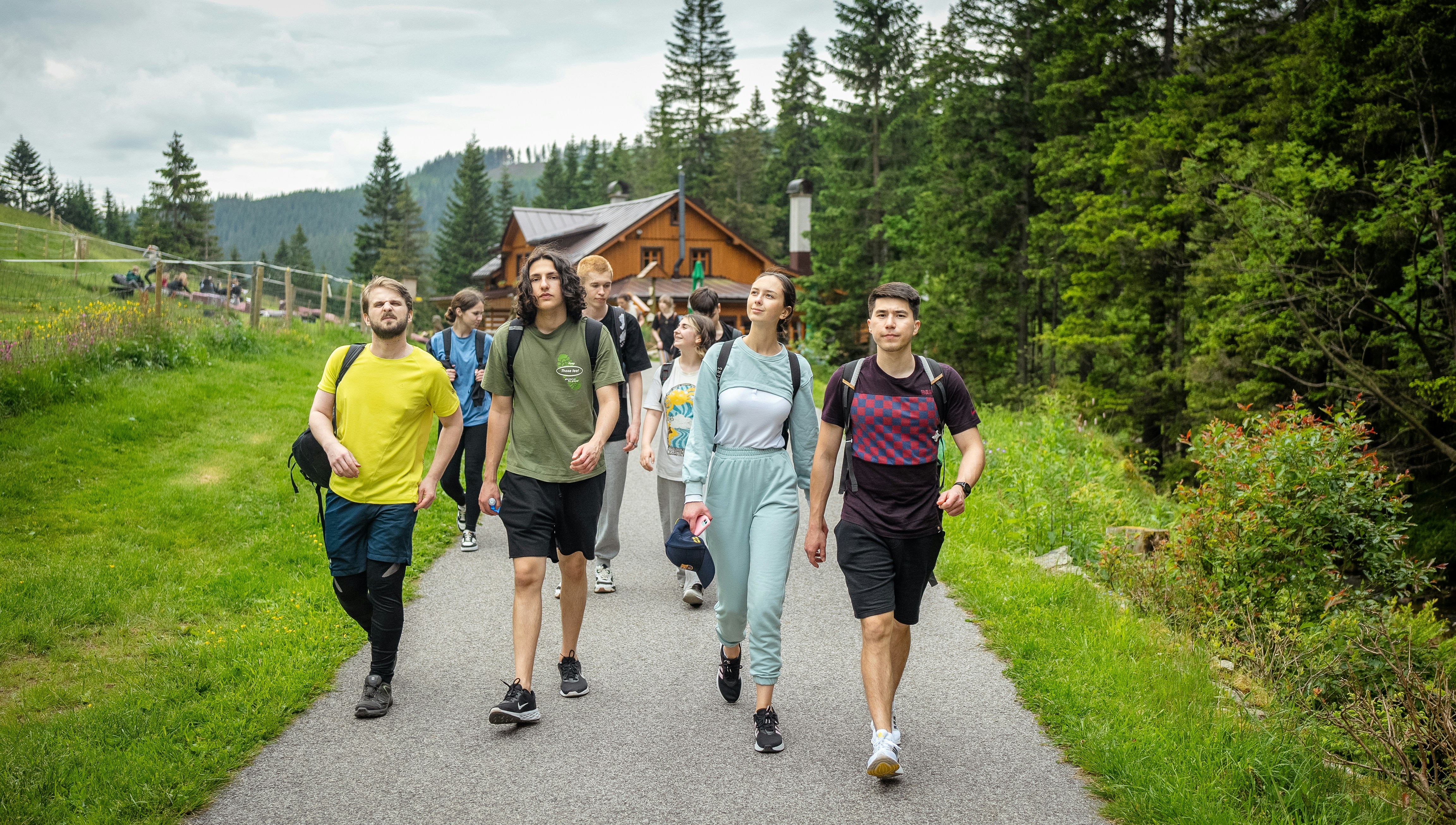 Group of hikers walking on a path in a forest.