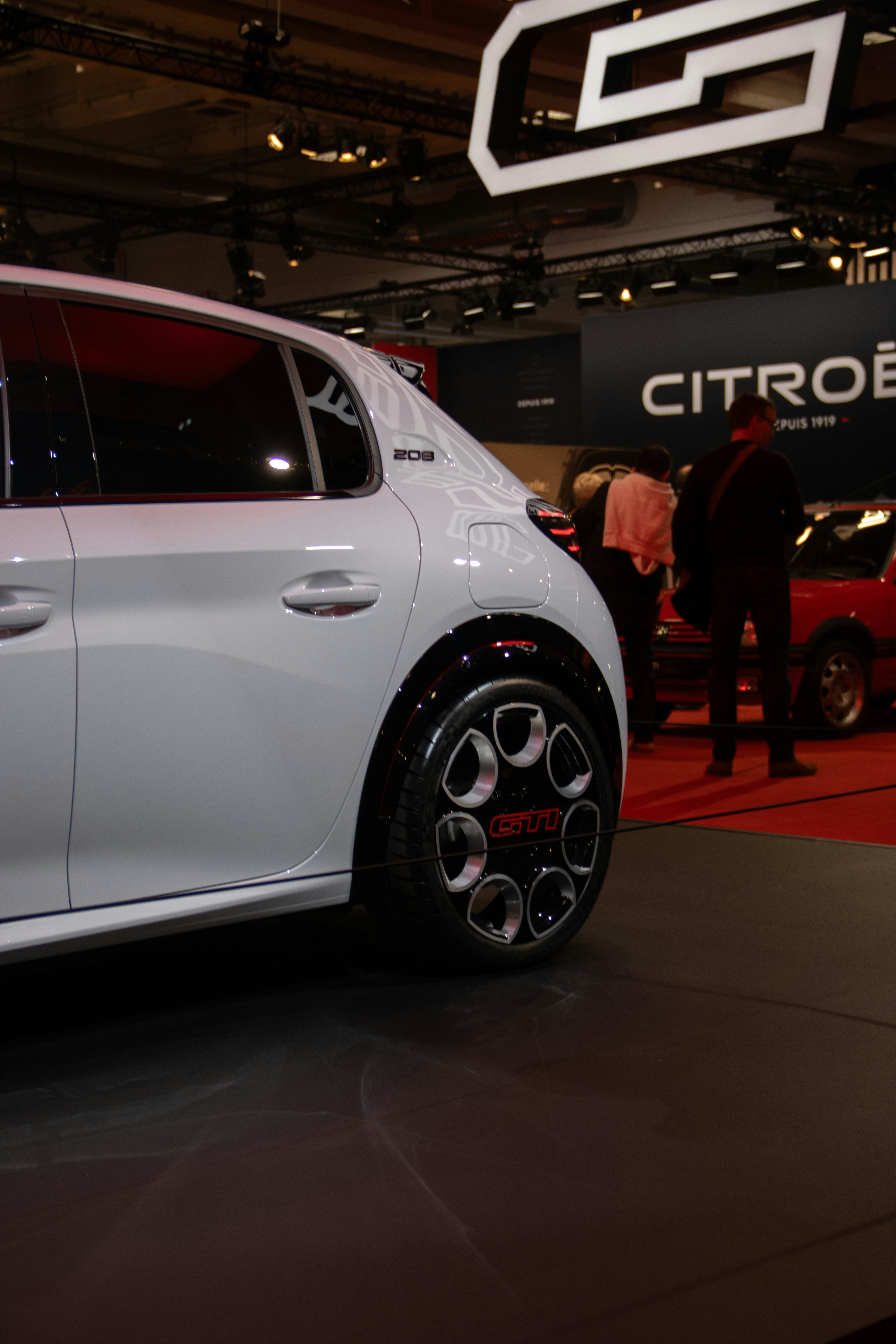 White citroen car displayed at an auto show.
