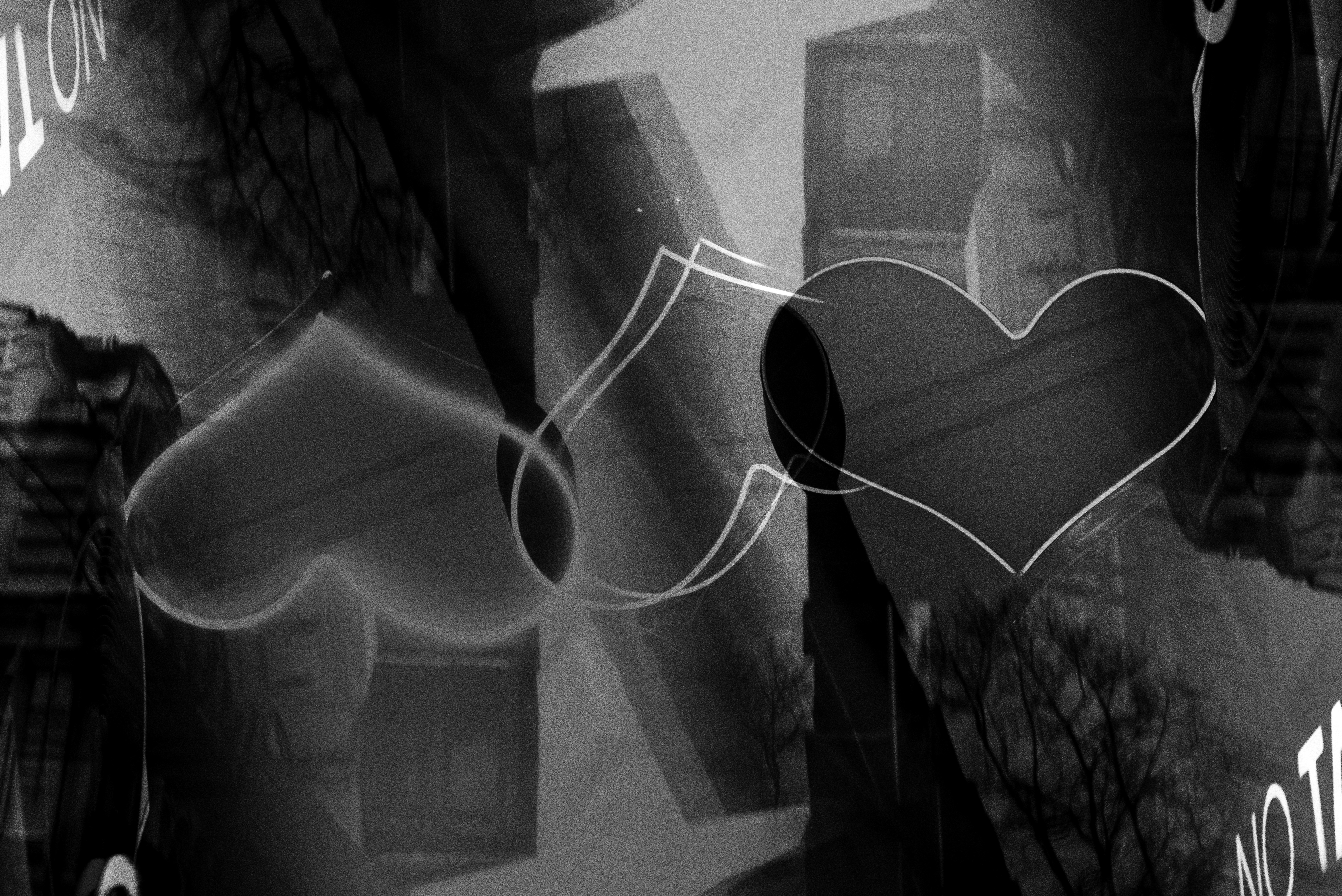 Two hearts overlapping in a grayscale abstract design