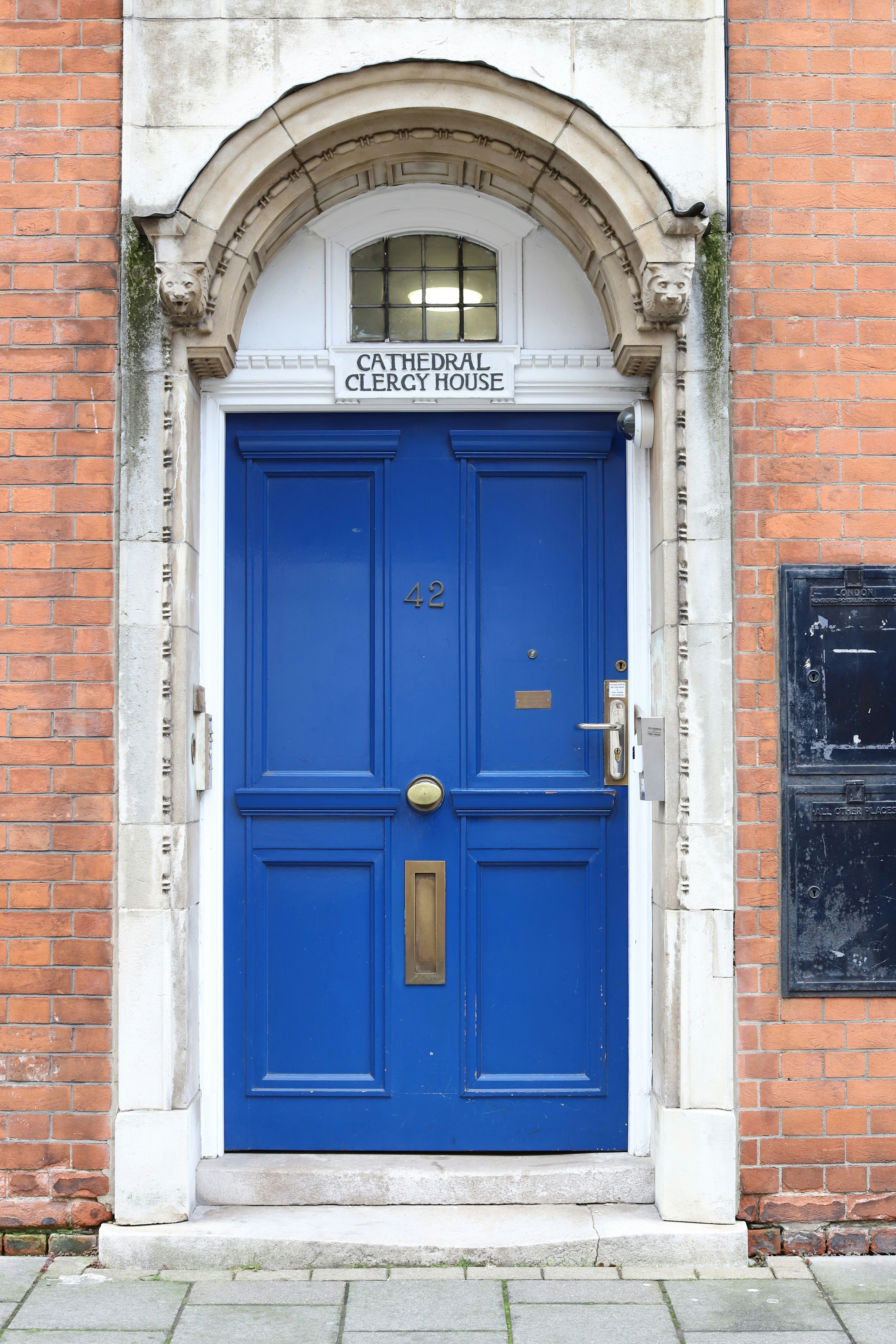 A bright blue door with brass fittings and gold accents.