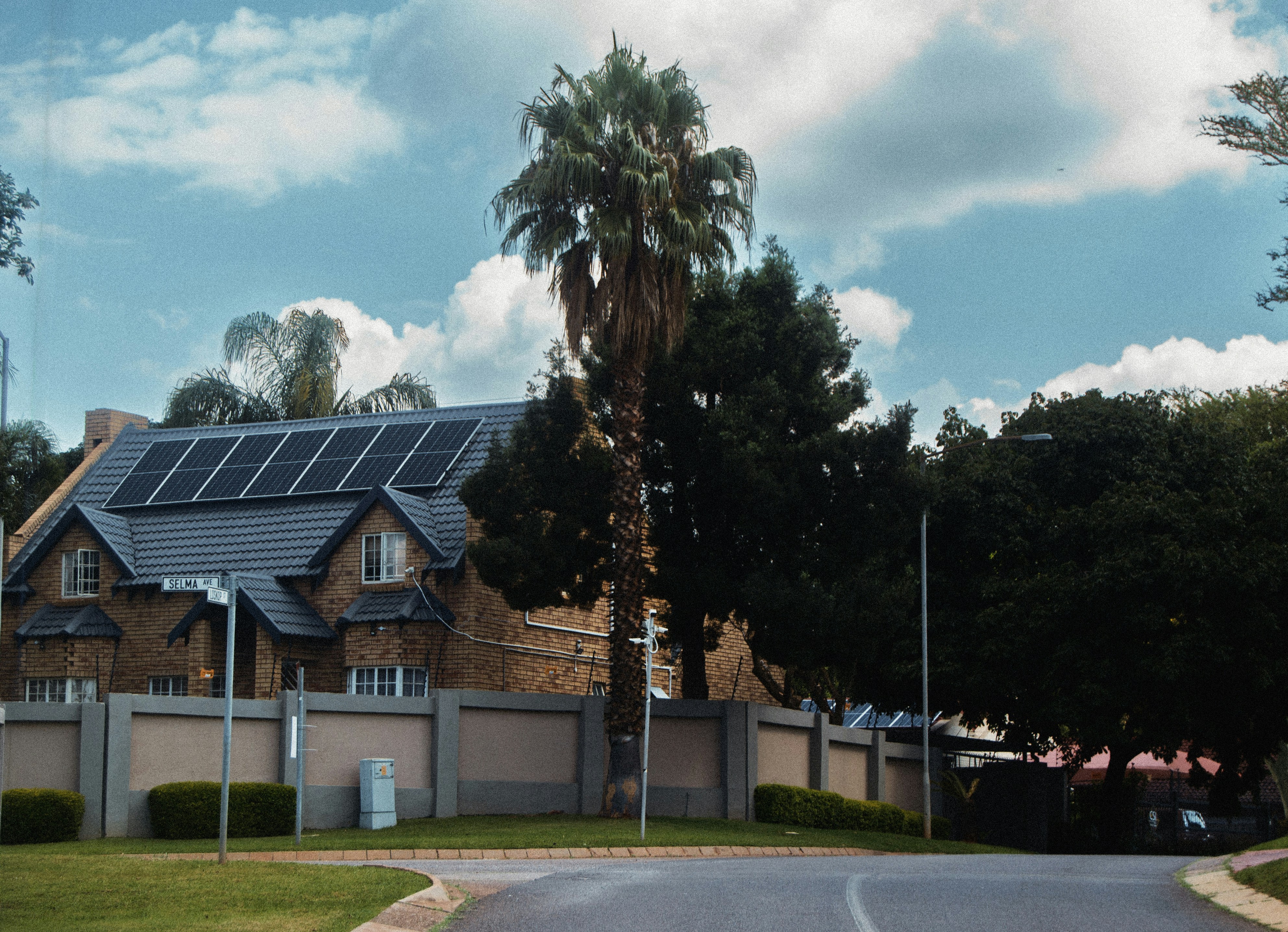 A large house with solar panels on the roof.