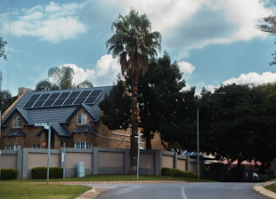 A large house with solar panels on the roof.