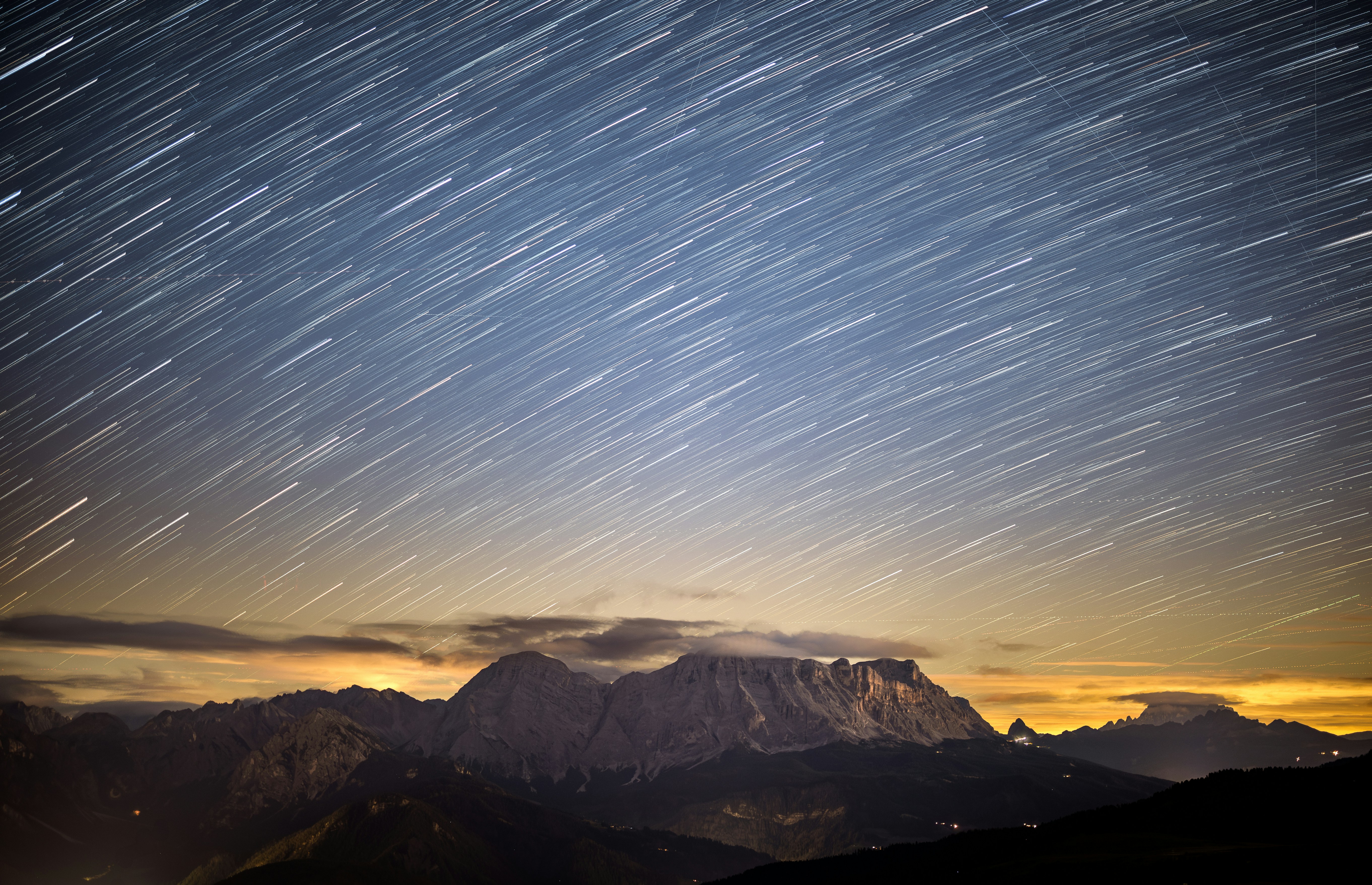 Star trails over mountain range at night