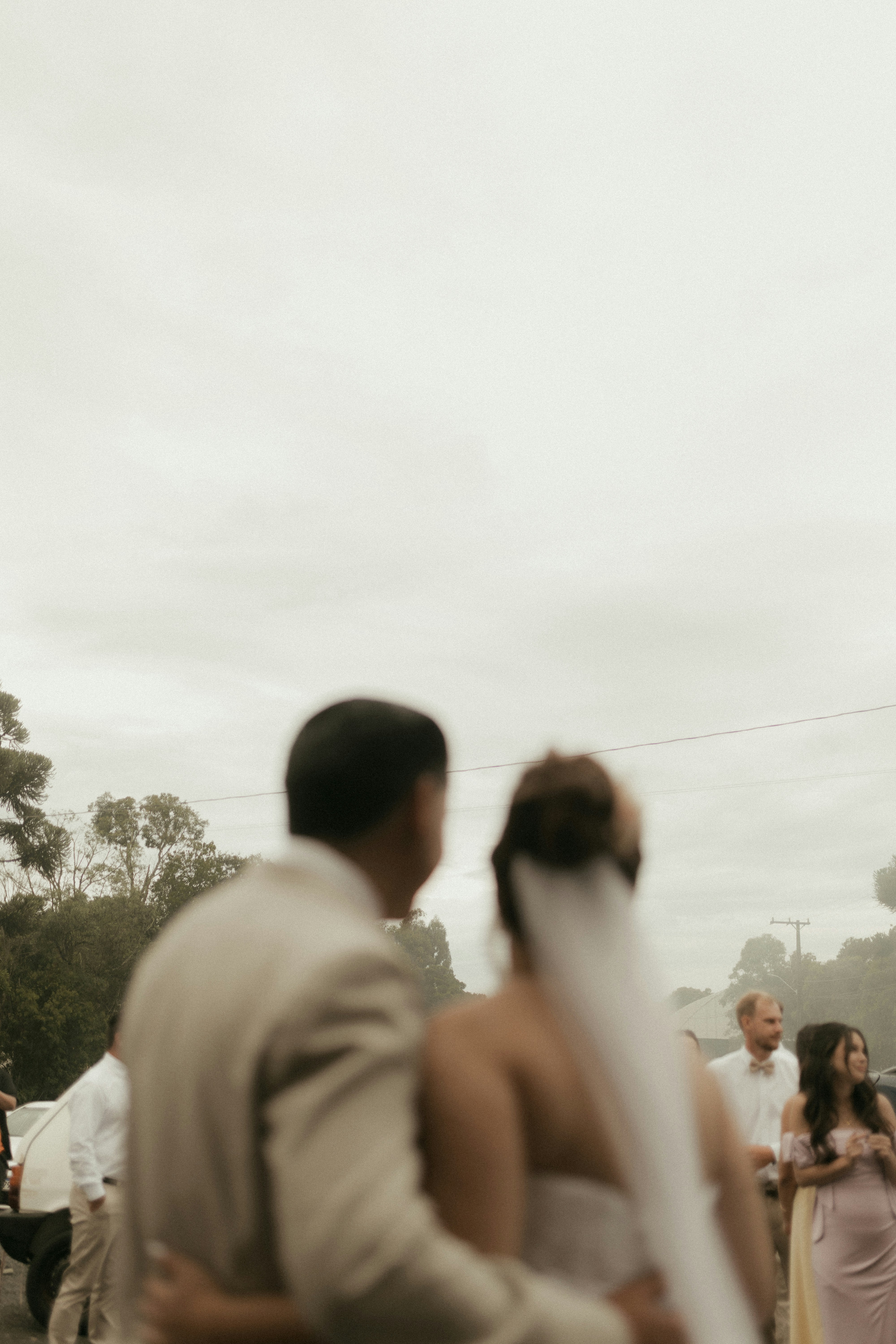 Mariée et marié avec invités à l’extérieur