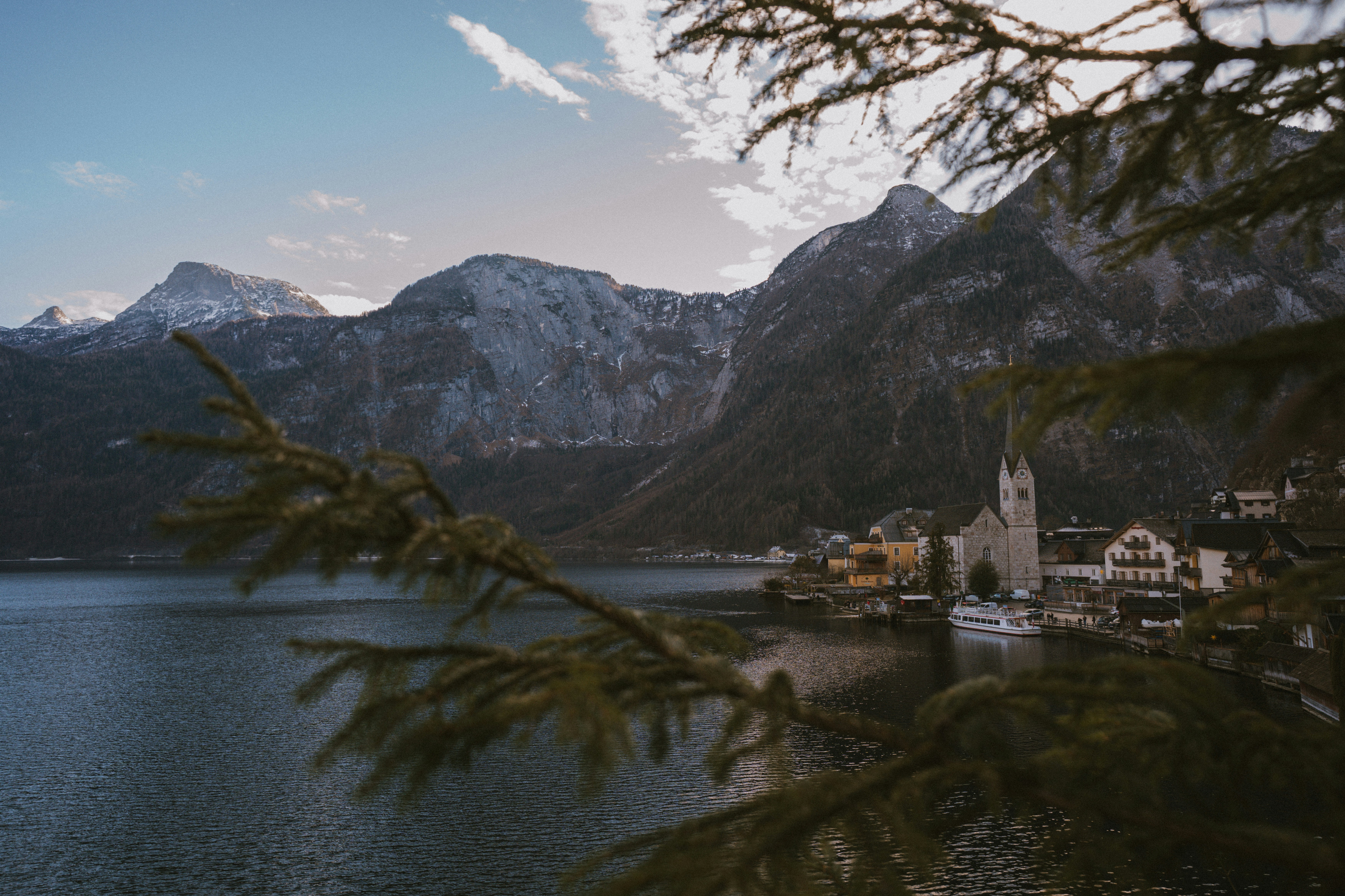 Village nestled by a lake with mountains behind