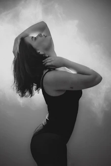 Woman in black tank top with head tilted back