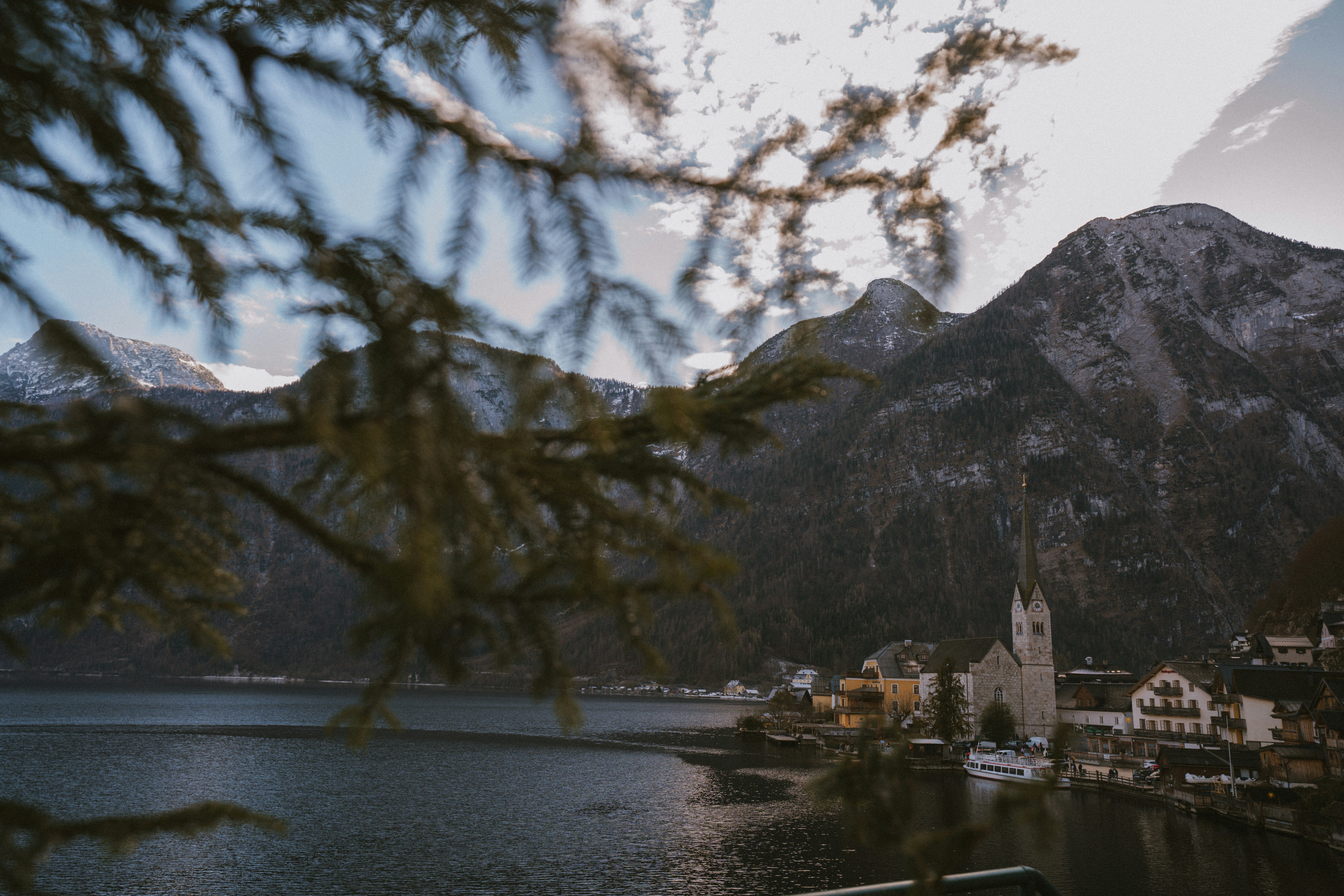 Mountain village on a lake with snow-capped peaks.