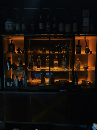 Bottles of liquor displayed on illuminated shelves