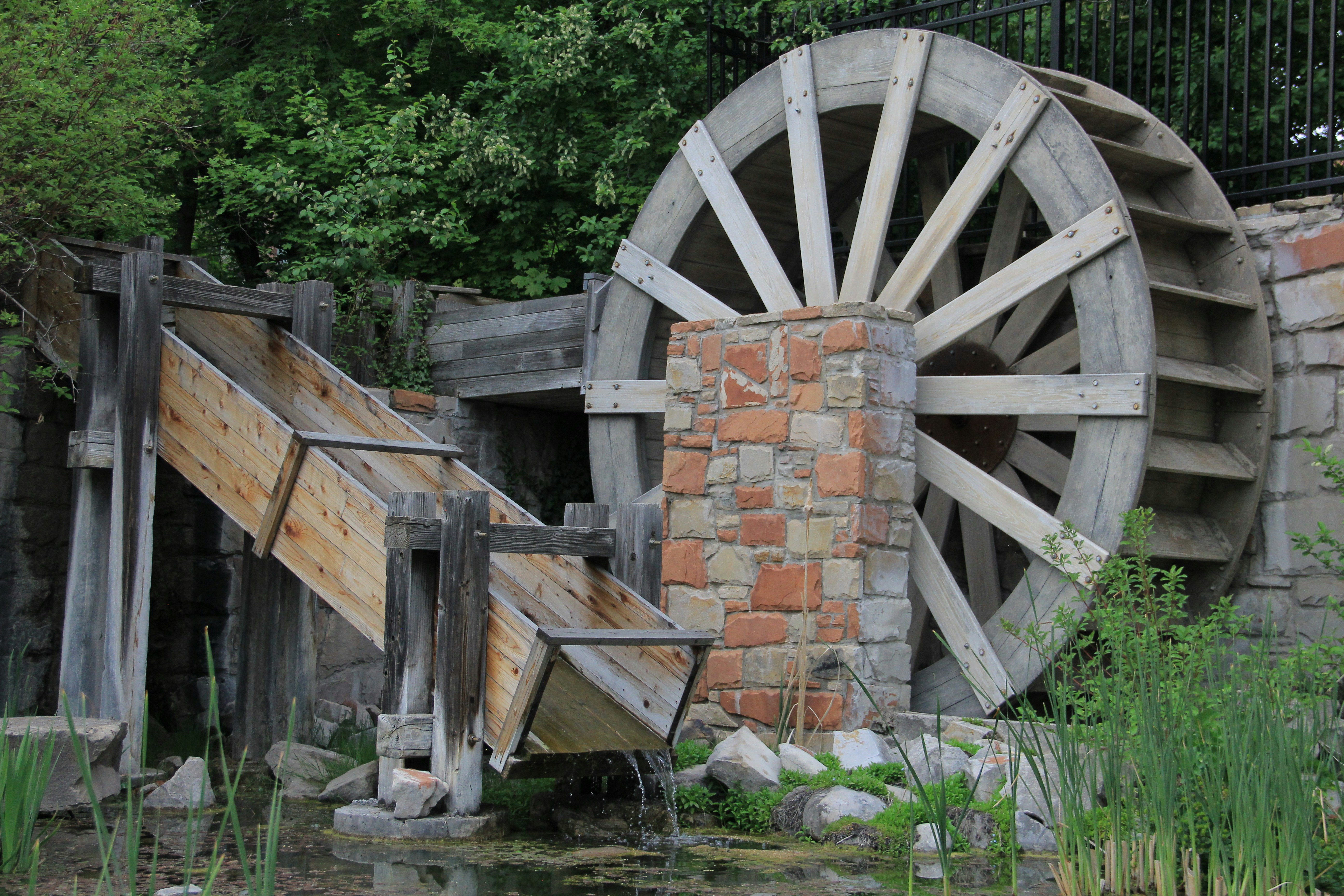 Wooden water wheel with a stone support structure.