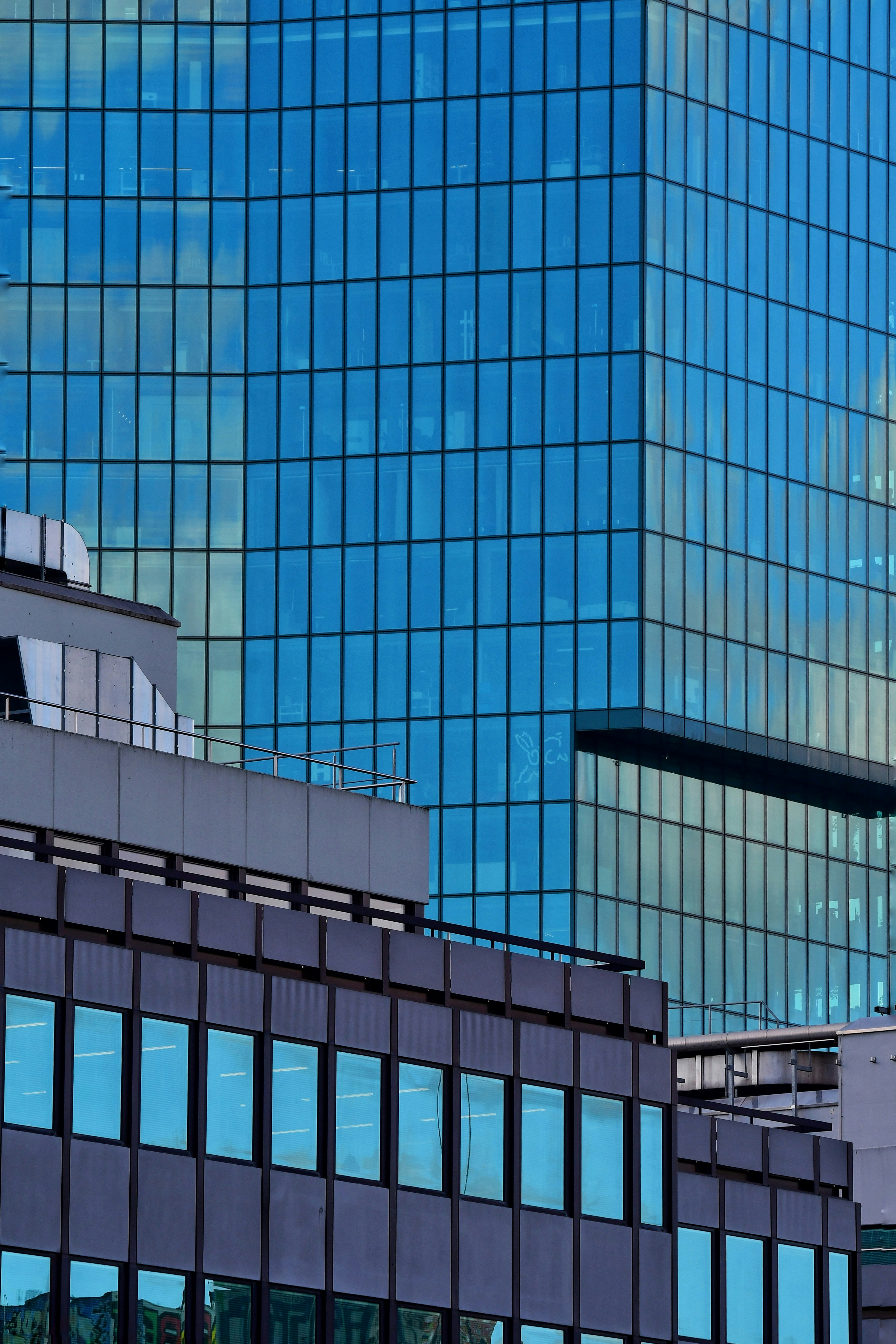 Modern glass buildings reflecting the sky