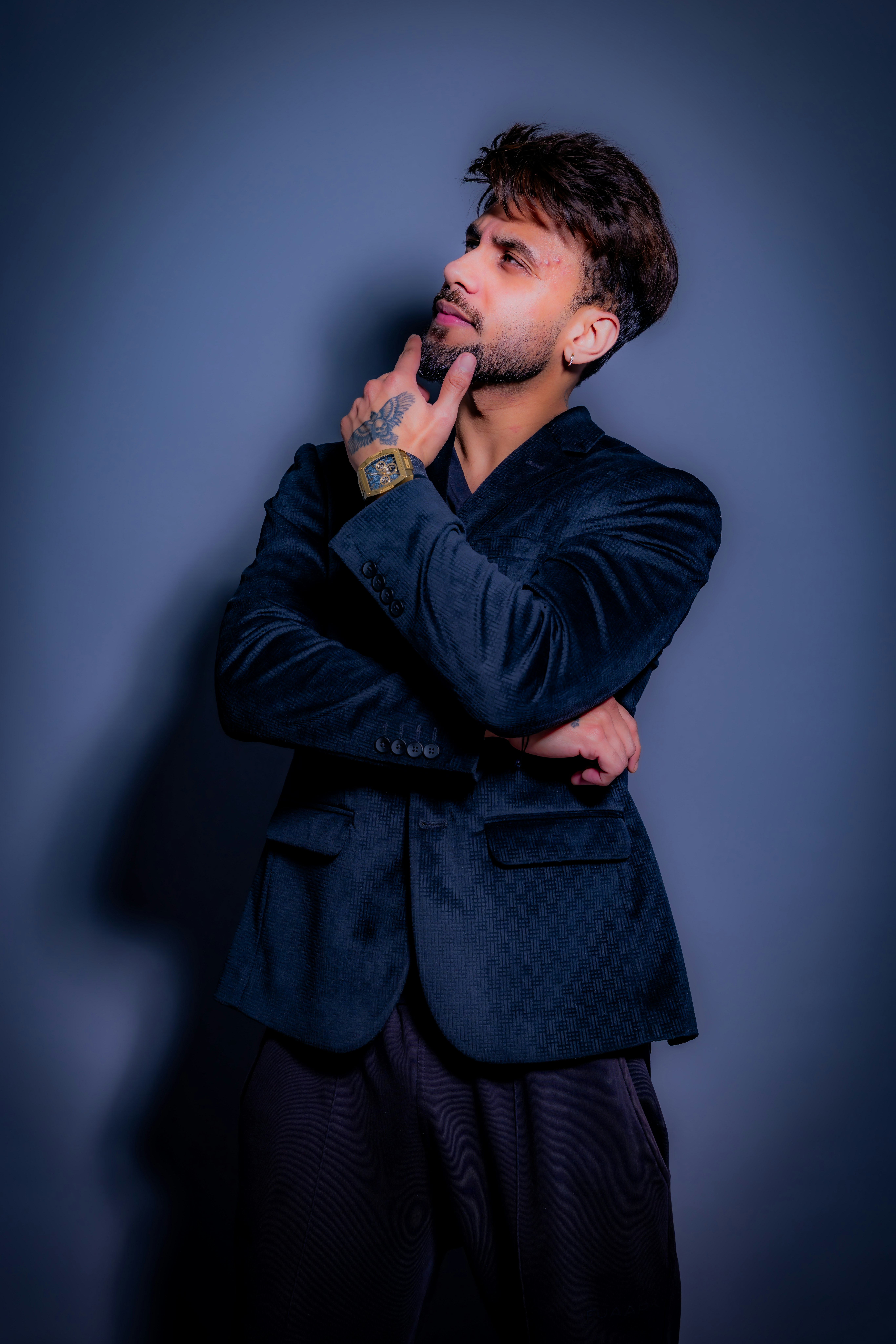 Man in a suit jacket thinking with hand on chin