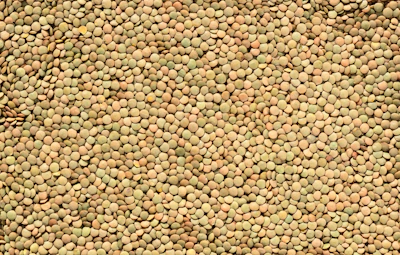 A pile of small, green lentils.