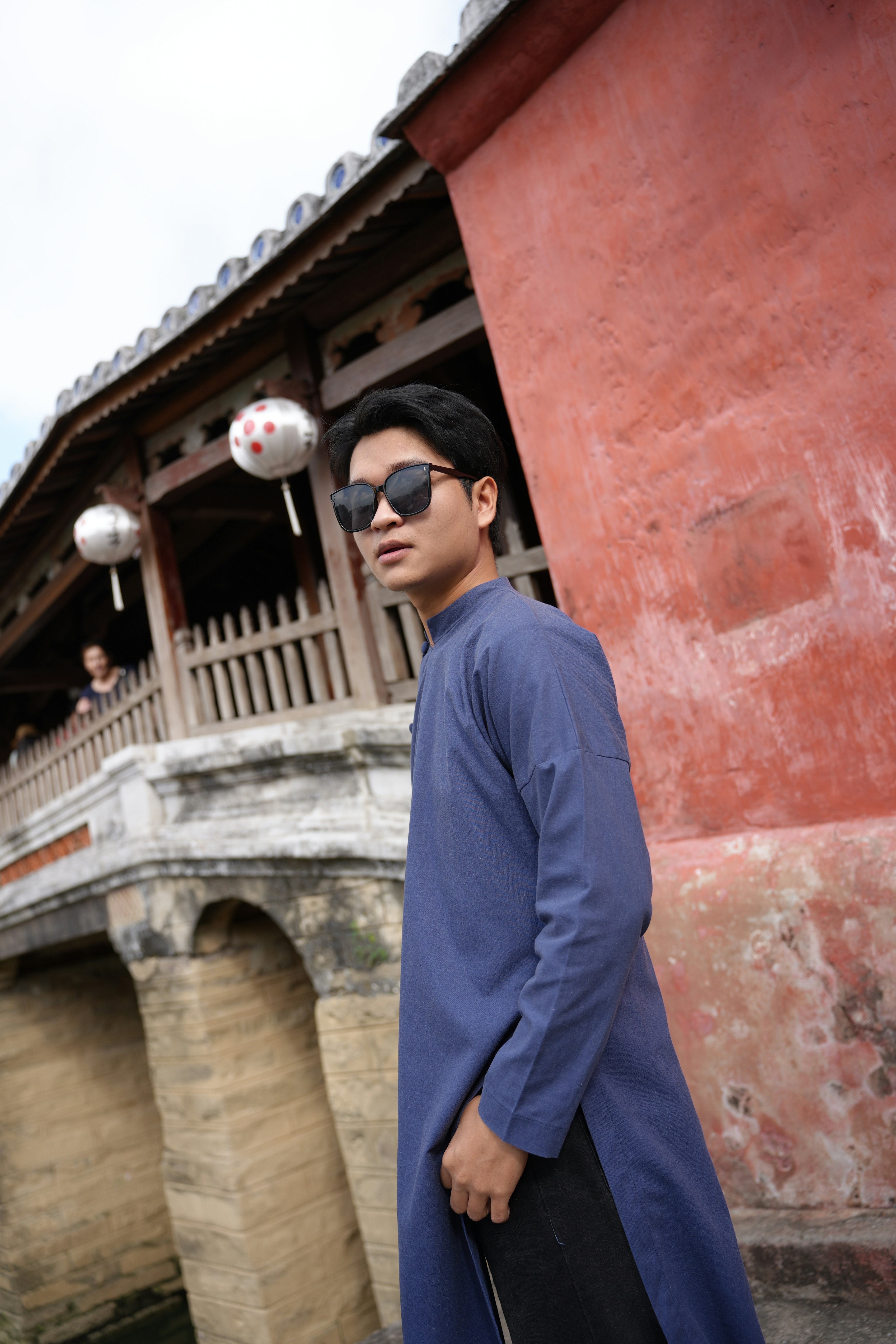Young man in traditional blue tunic and sunglasses
