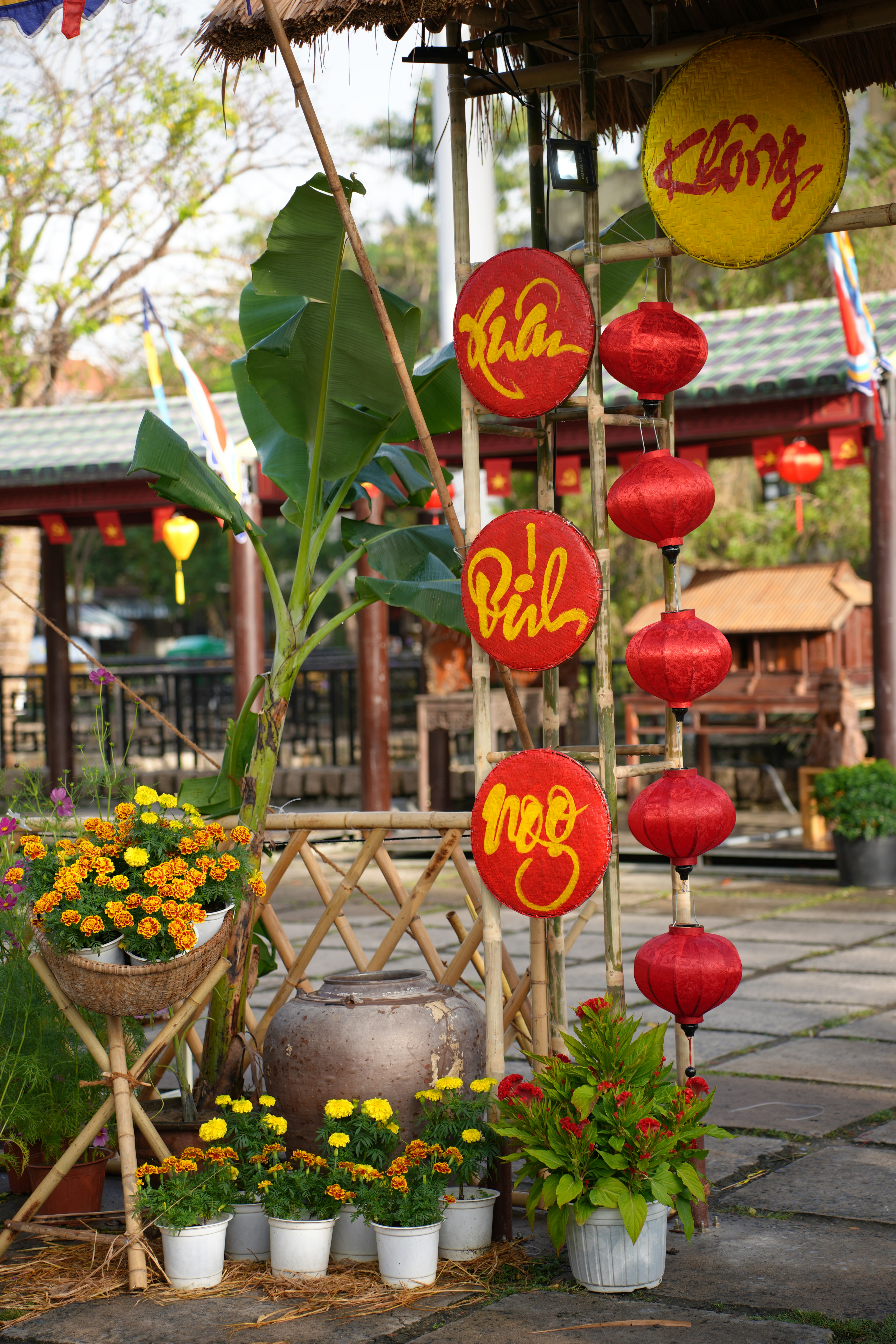 Red lanterns and yellow decorations hang outdoors.