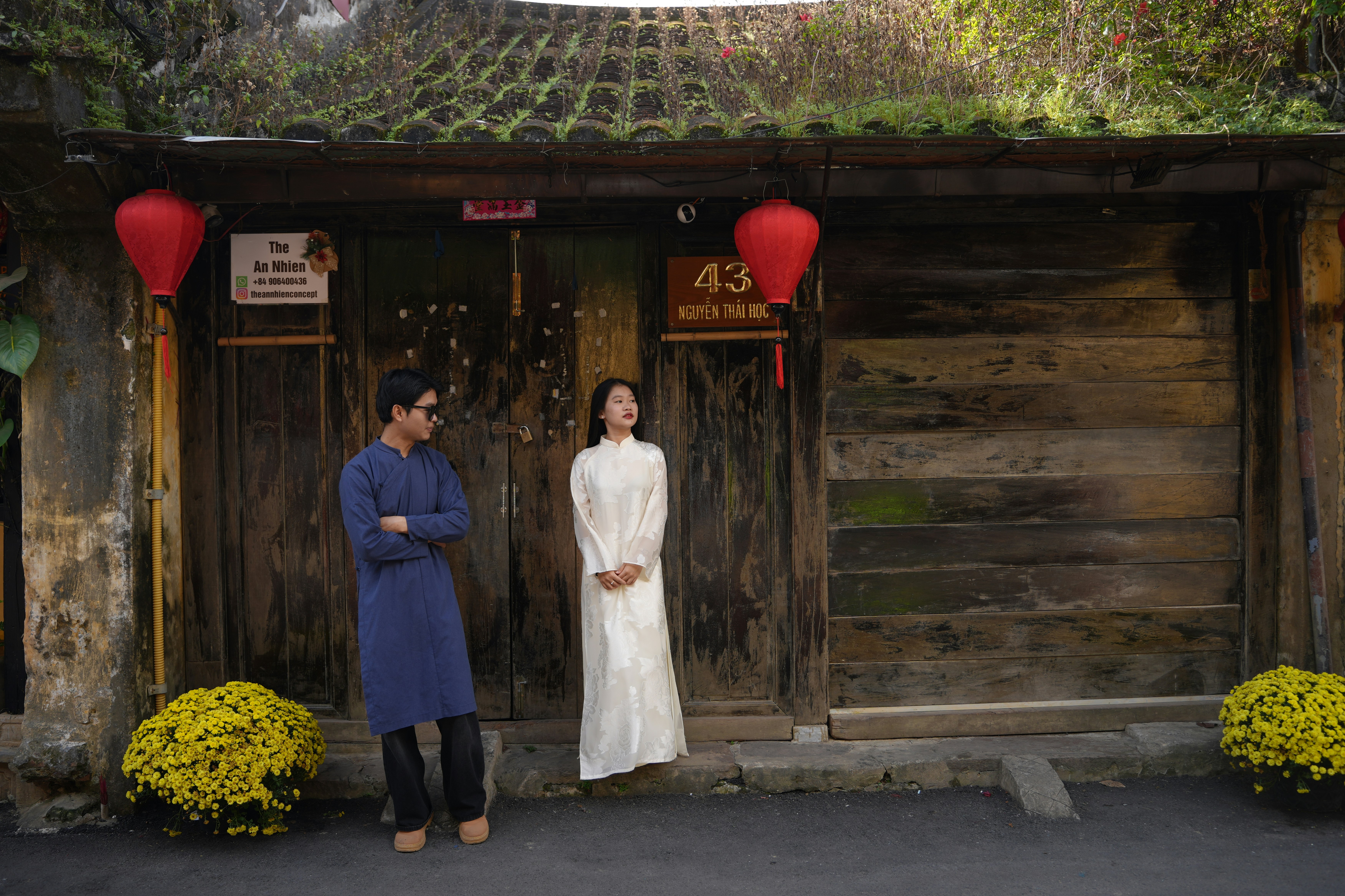 Couple in traditional clothing standing outside old building