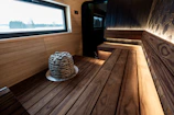 Interior of a modern wooden sauna with stone heater.