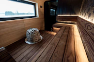 Interior of a modern wooden sauna with stone heater.