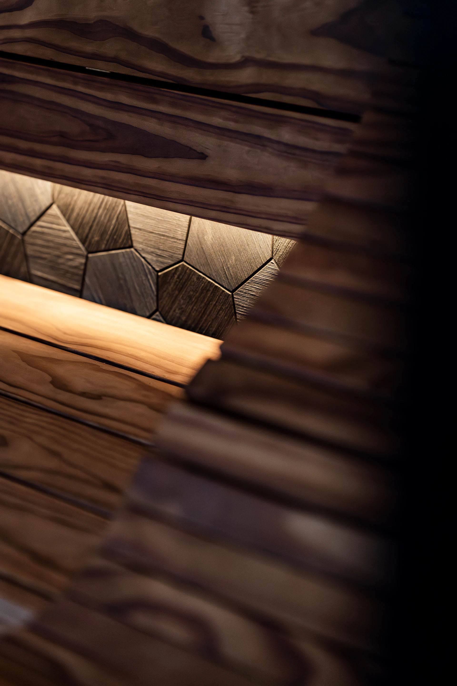Textured wooden wall with geometric pattern and lighting