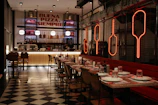 Modern restaurant interior with checkered floor and neon signs