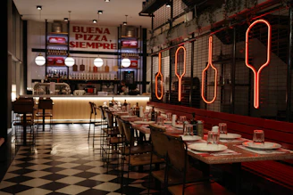 Modern restaurant interior with checkered floor and neon signs