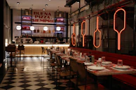 Modern restaurant interior with checkered floor and neon signs