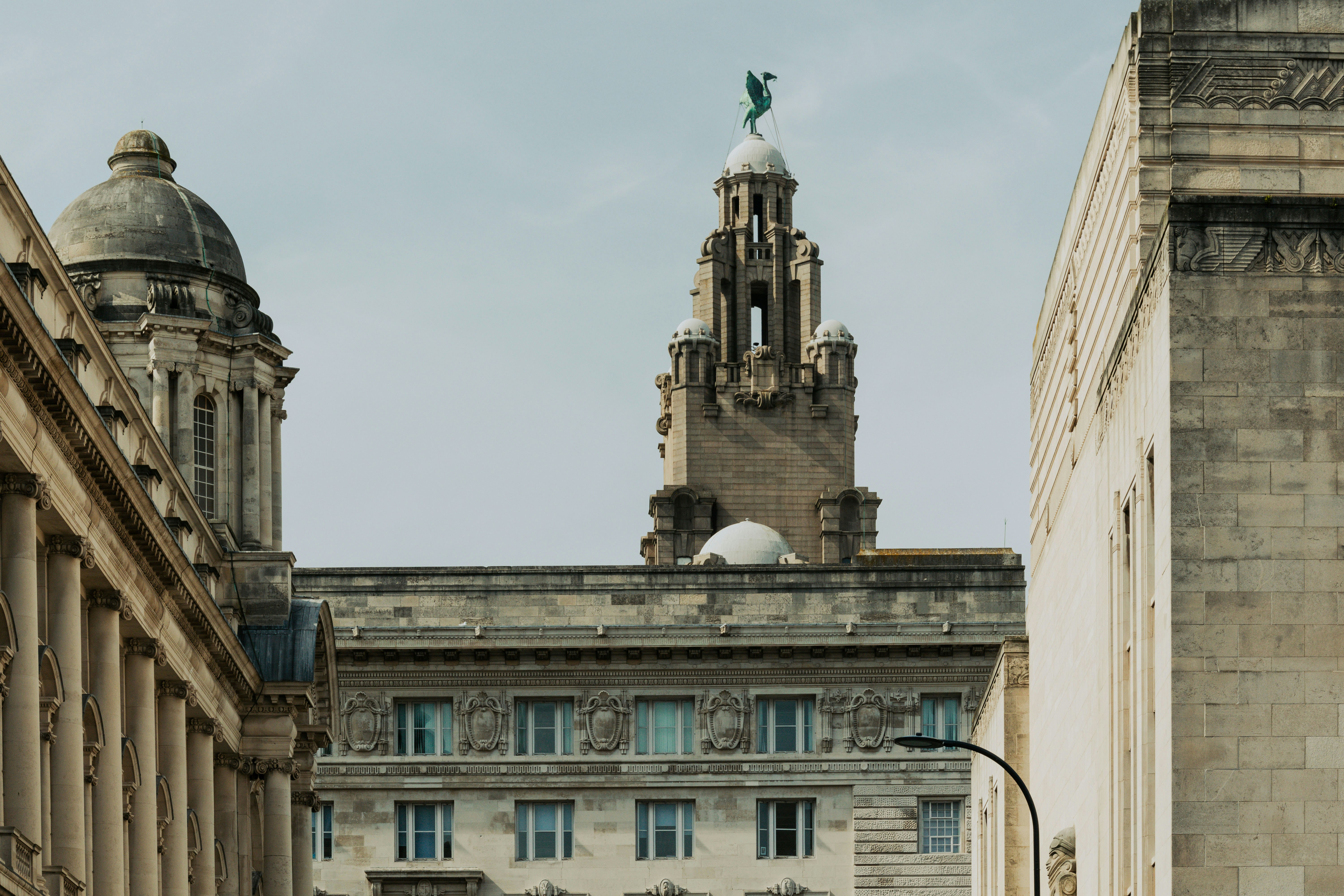 Ornate buildings with a detailed tower against sky