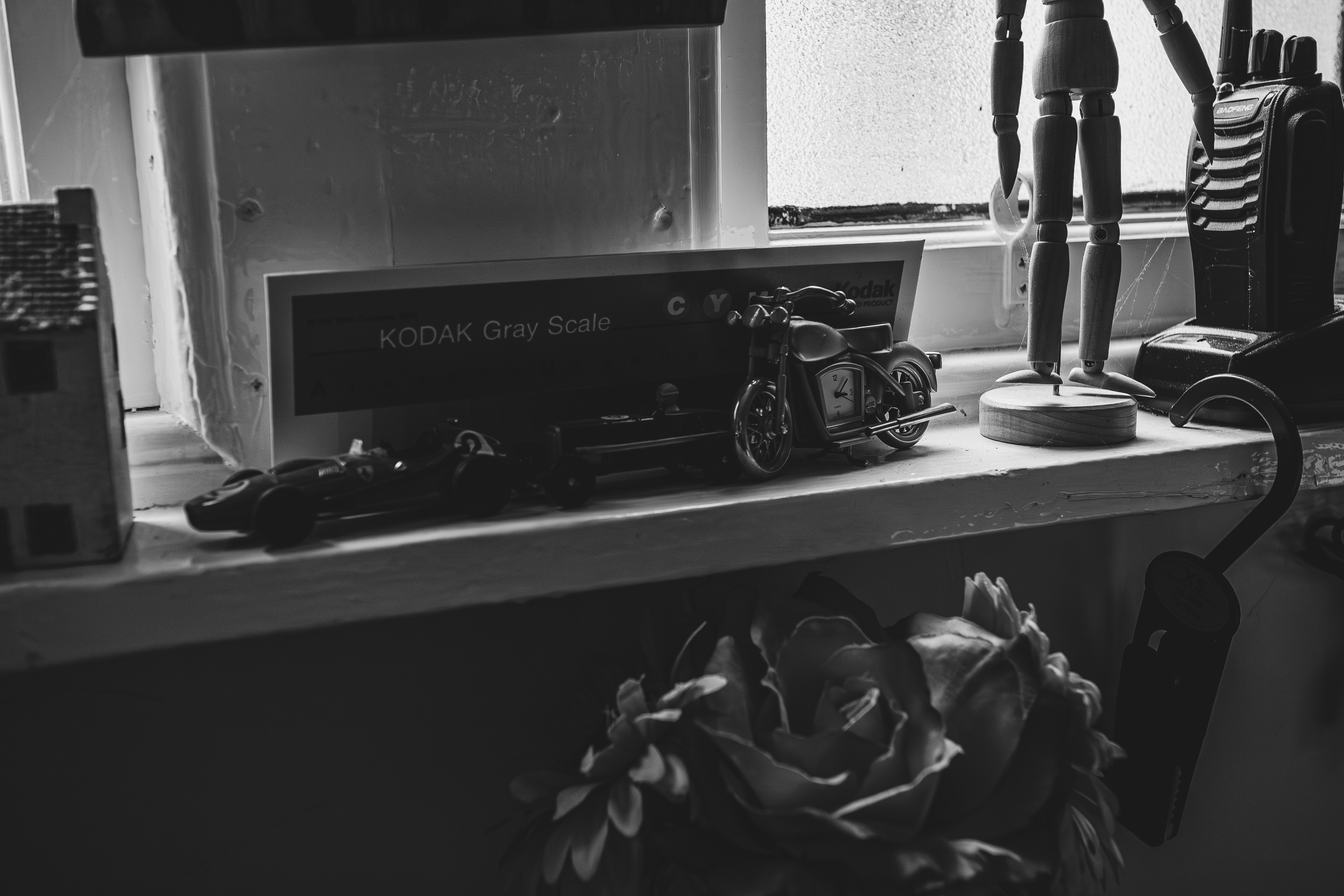 Sammlung von Objekten auf einem Regal mit einer Blume