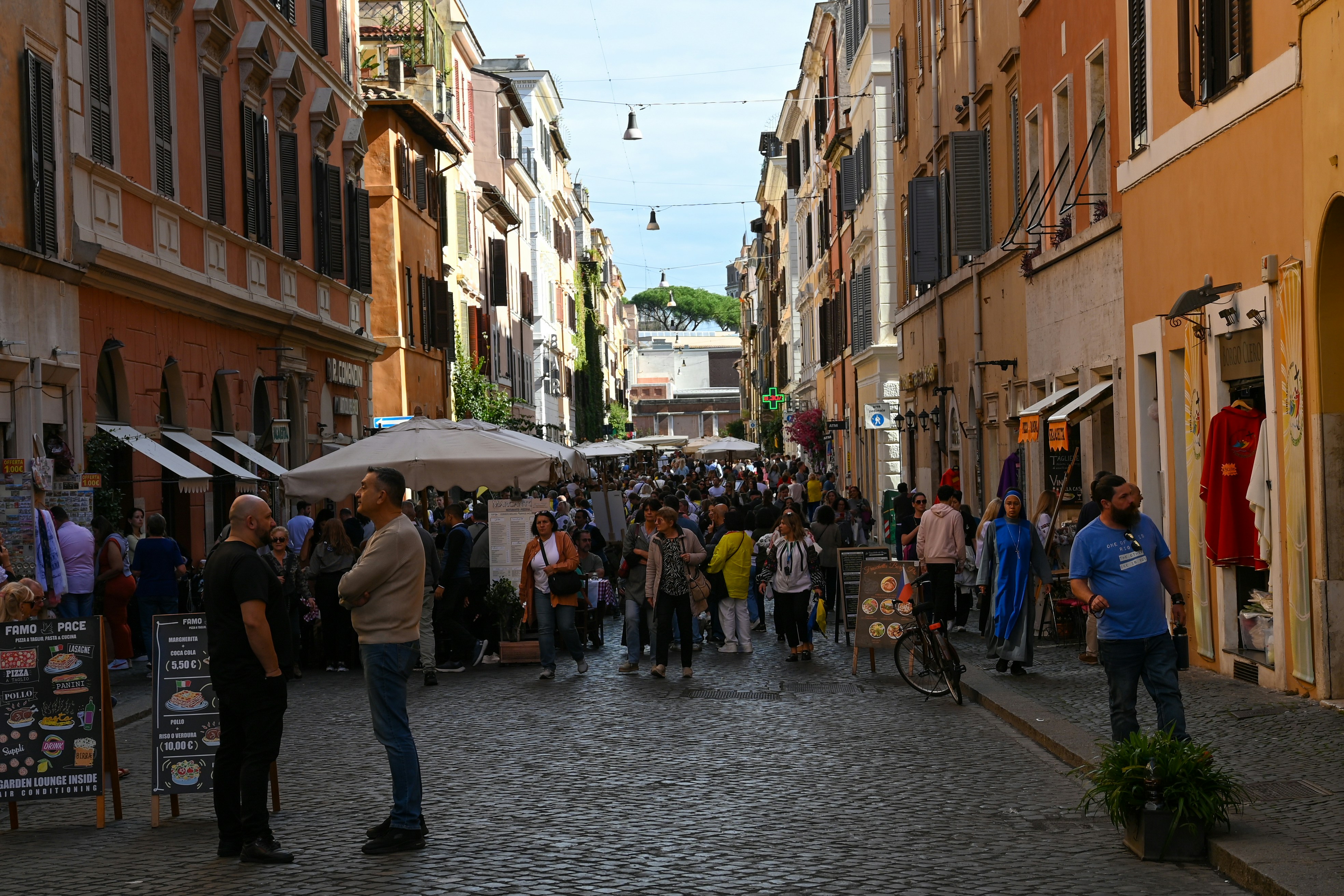 Crowded street with shops and people in italy