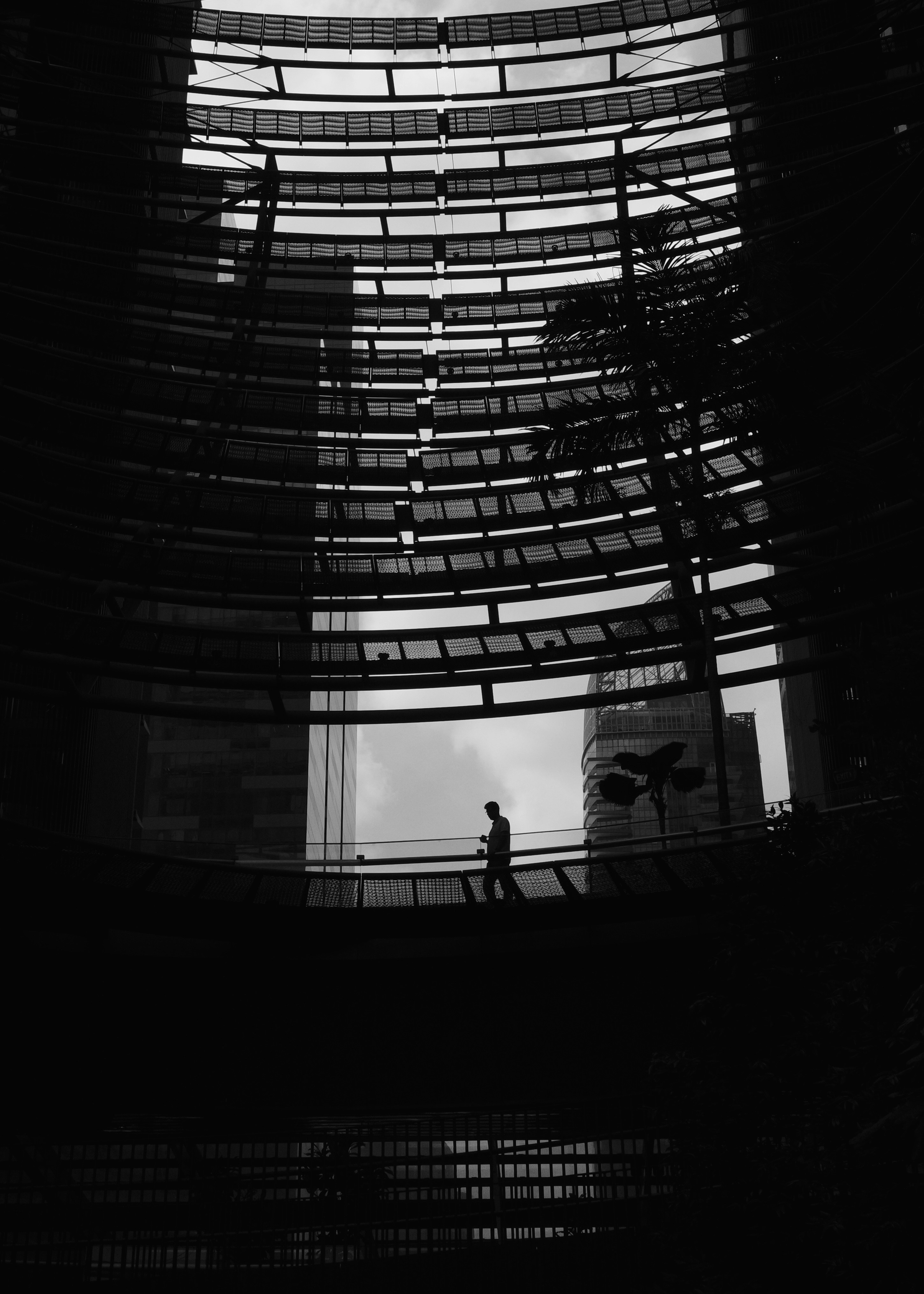 Silhouette of a man walking on a walkway