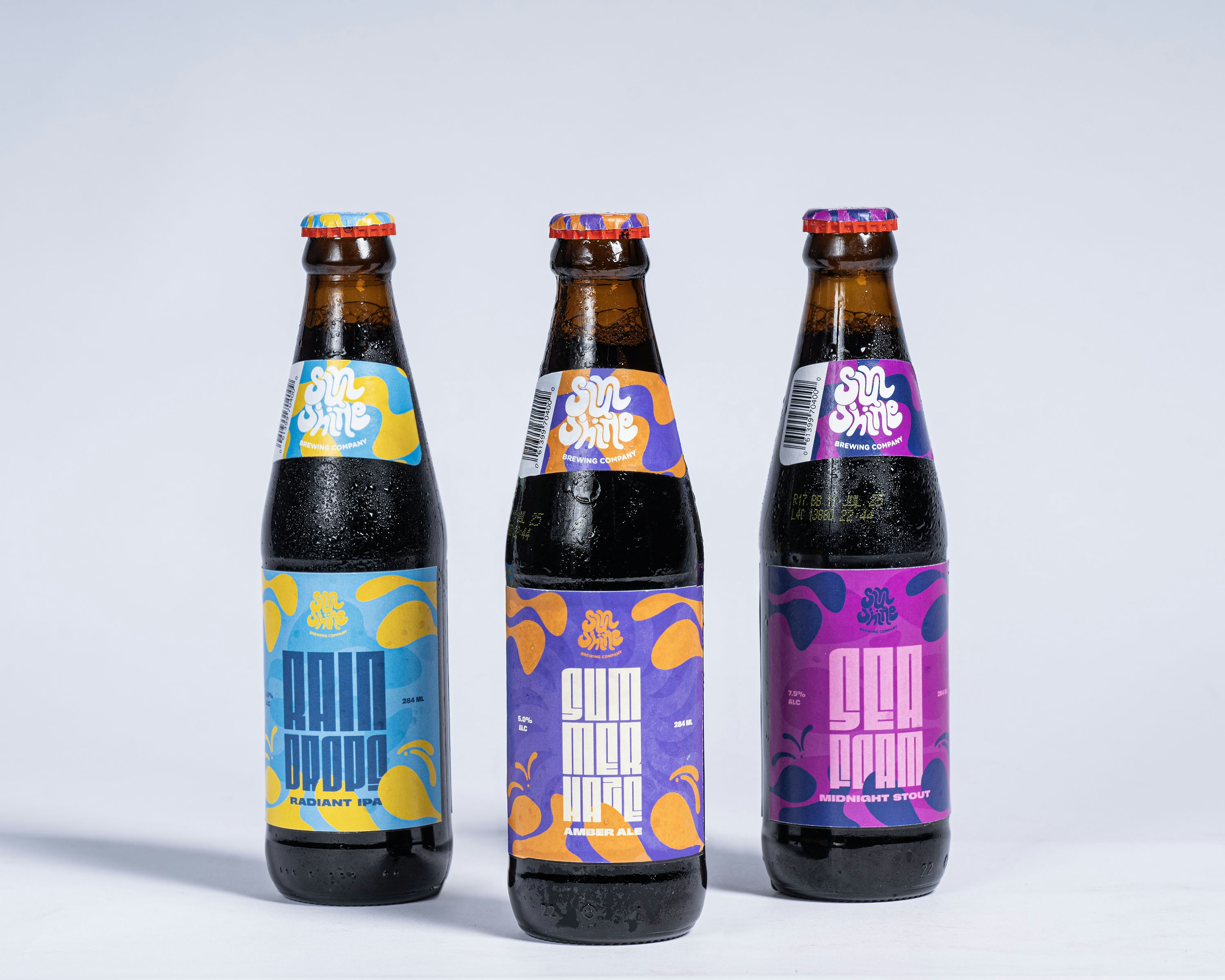 Three colorful craft beer bottles on white background