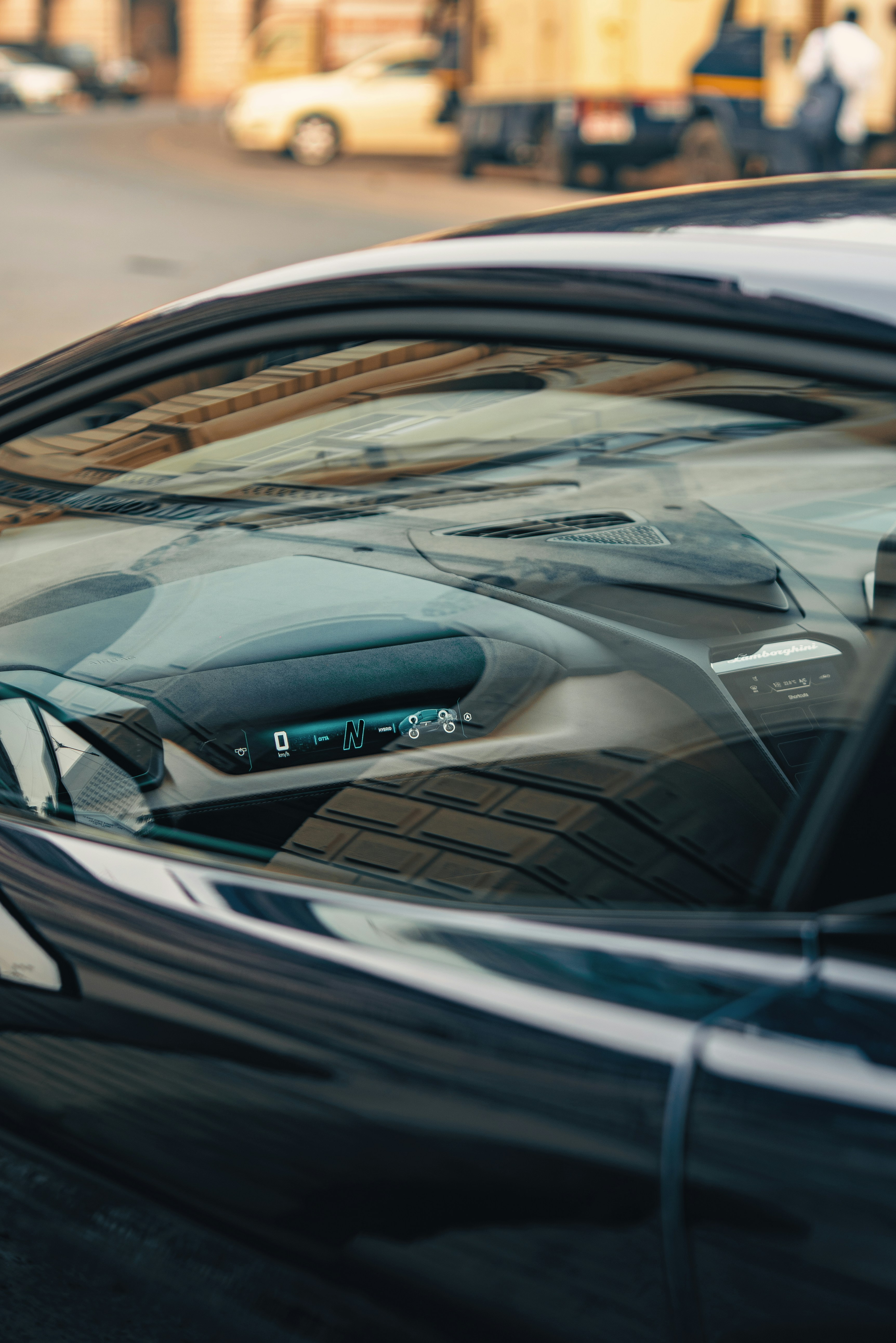 Close-up of a modern car's dashboard and windshield.