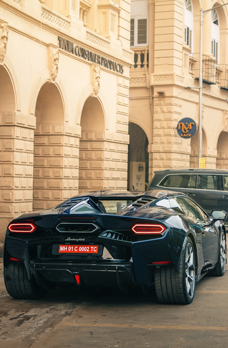 Black luxury sports car parked on an urban street