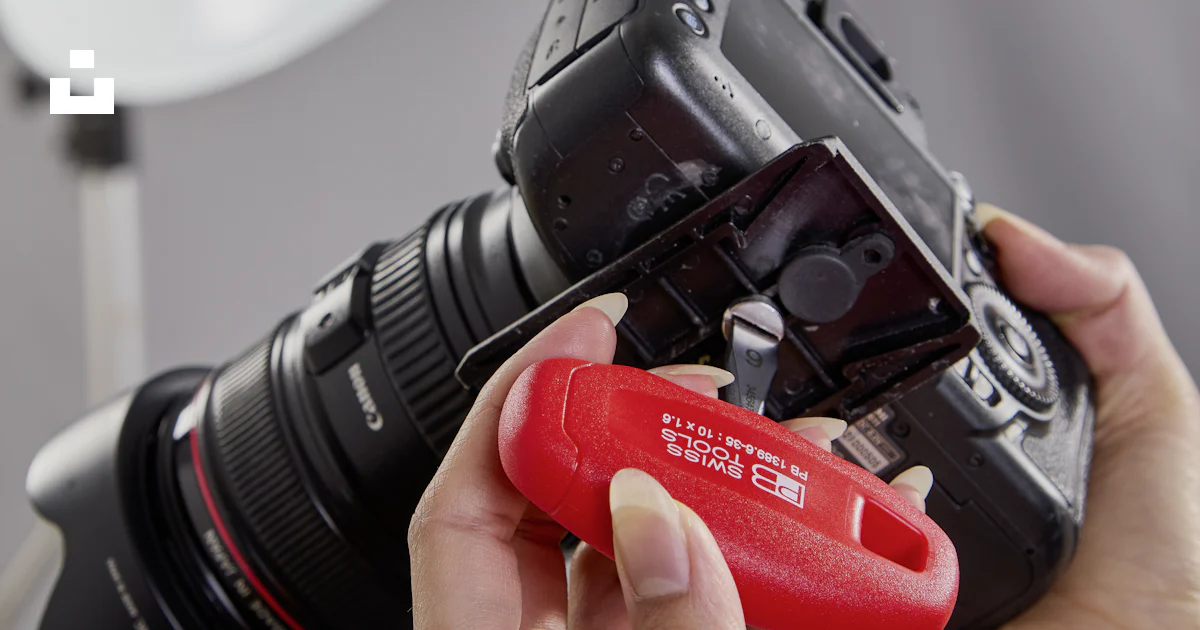 Camera Channel Tag Hands attaching a red tag to a professional camera. photo – Free ...