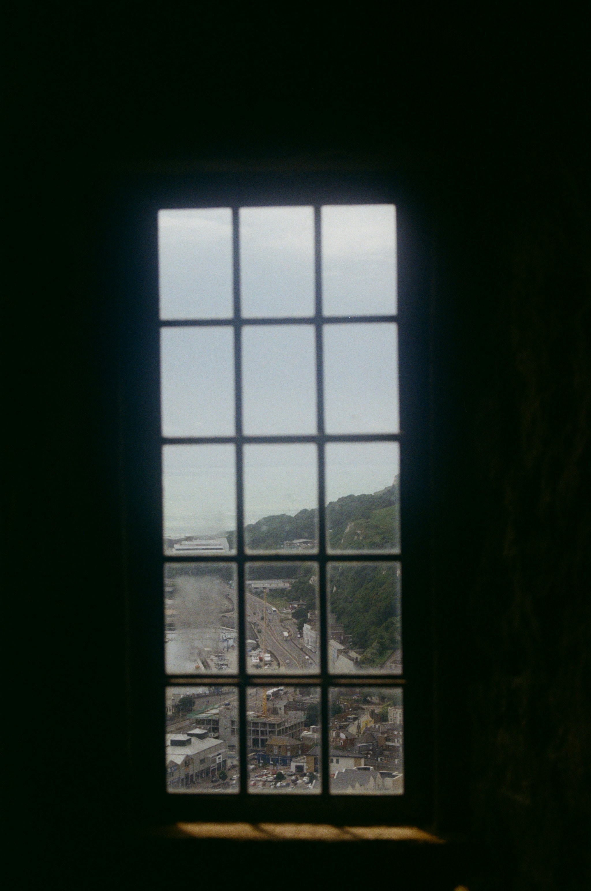 View through a window of a highway and cityscape.