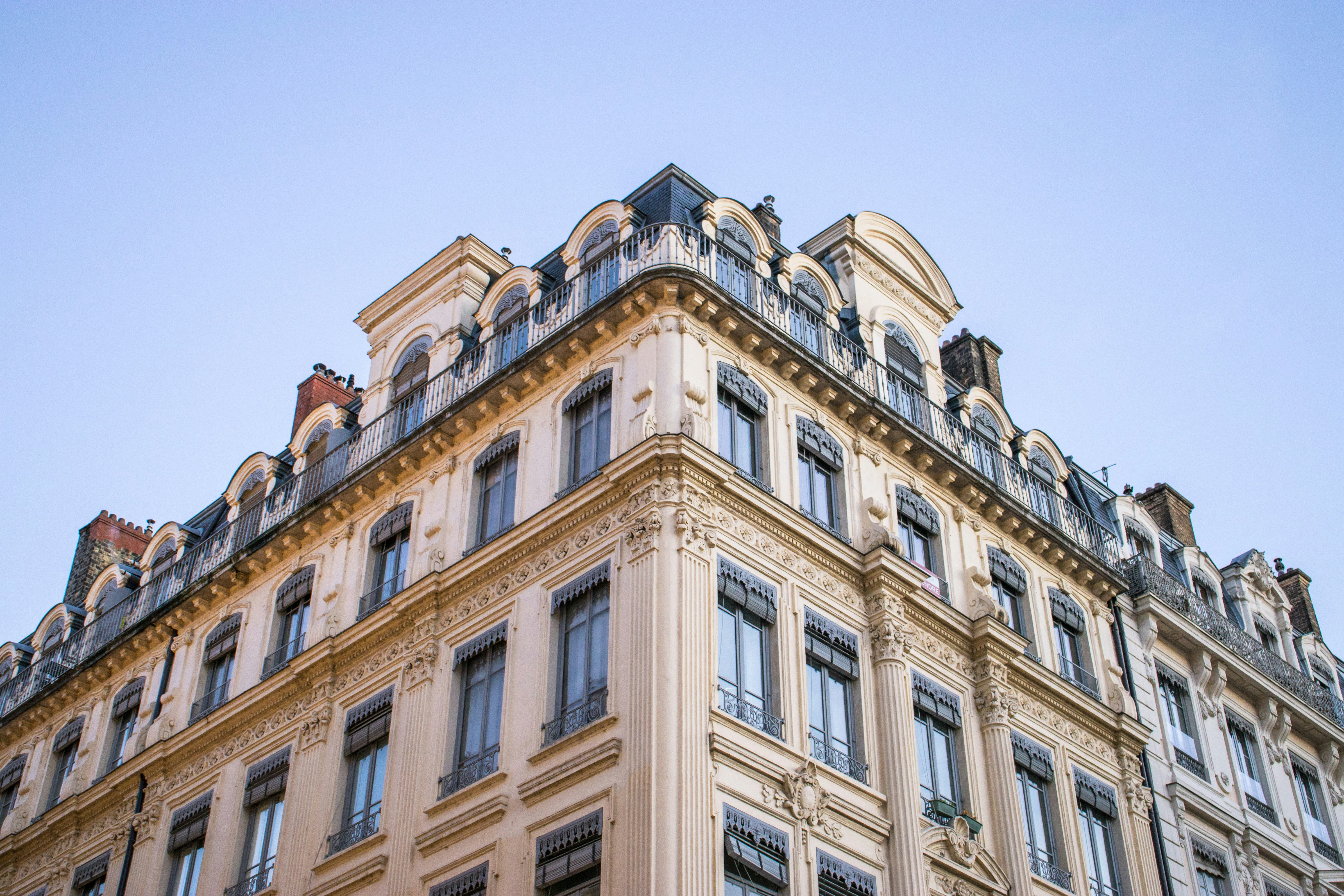 Classic european building with mansard roof under sky