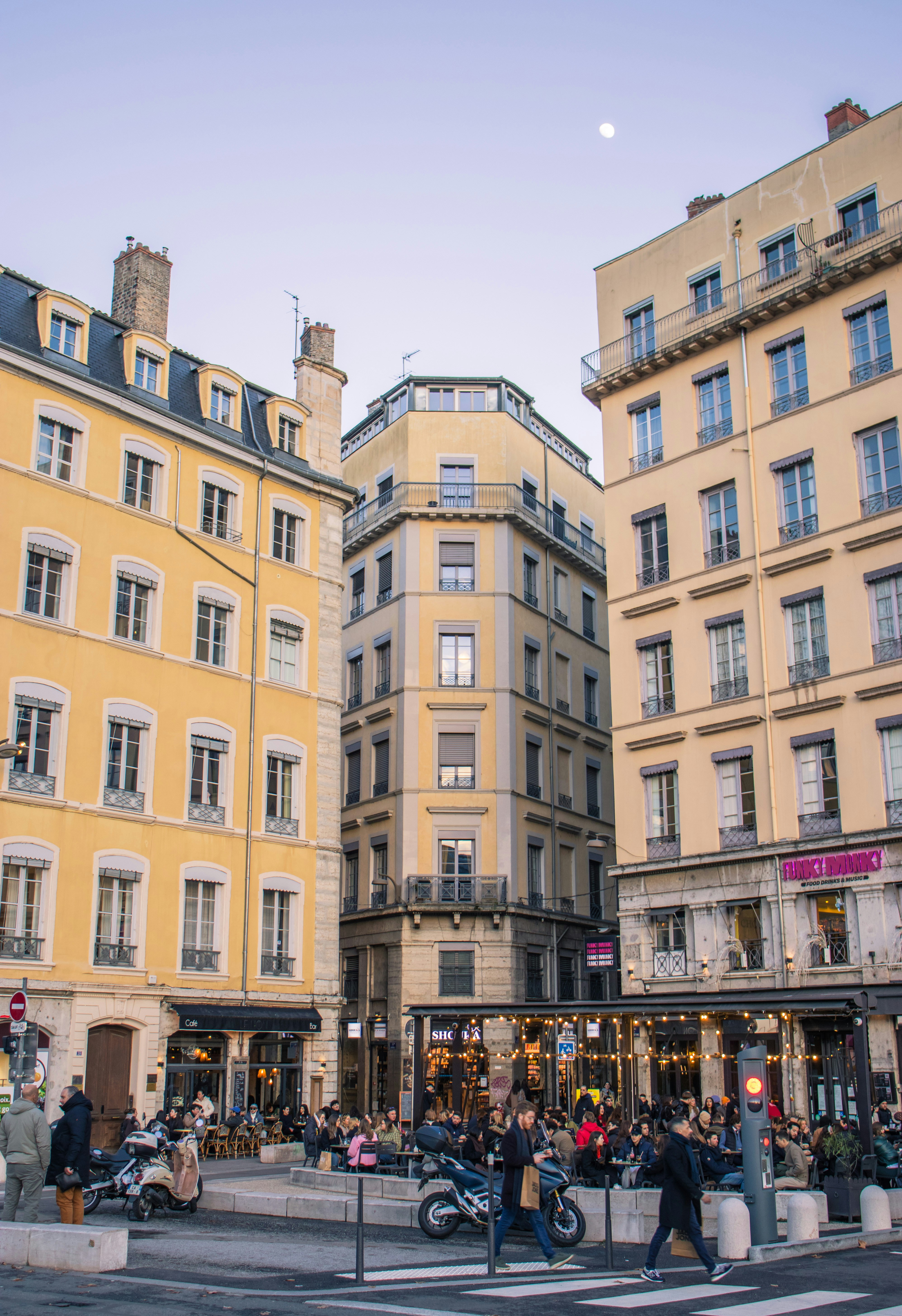 People enjoying outdoor dining at a european city square.