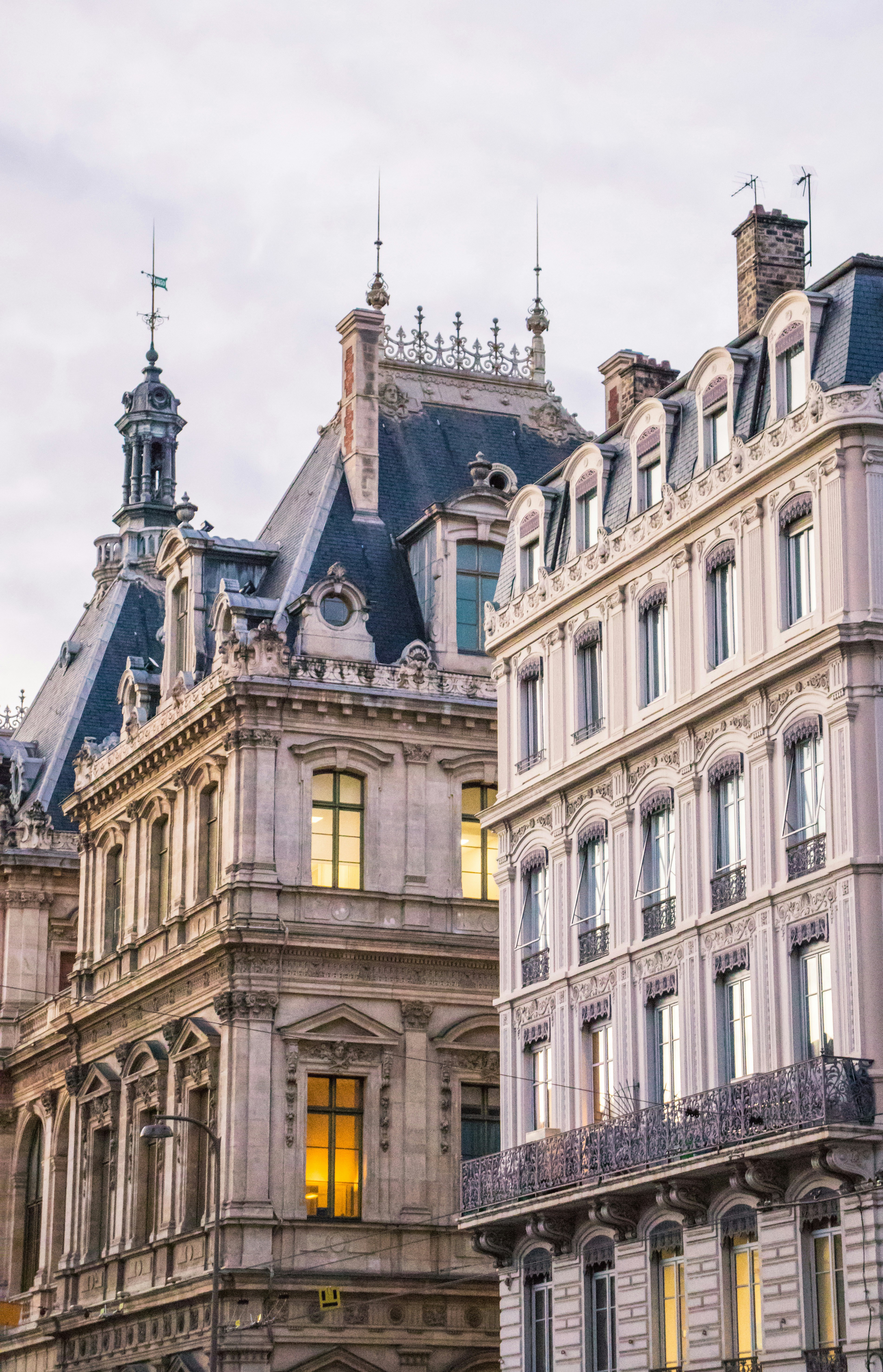 Ornate buildings with detailed architecture under a pale sky.