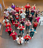Group of people forming a heart shape with hands