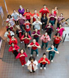 Group of people forming a heart shape with hands