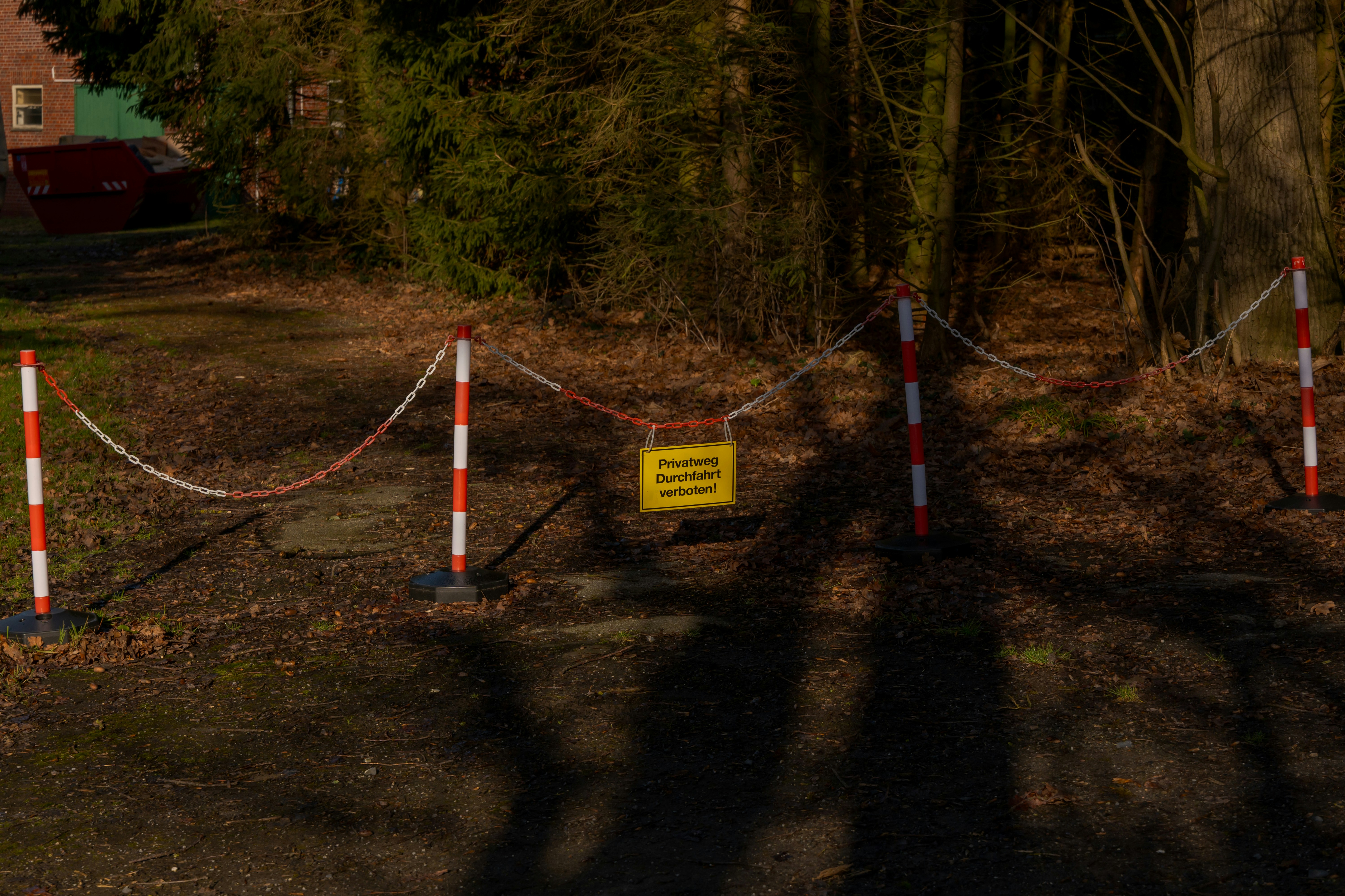A yellow sign on a barrier tape reads "private property"