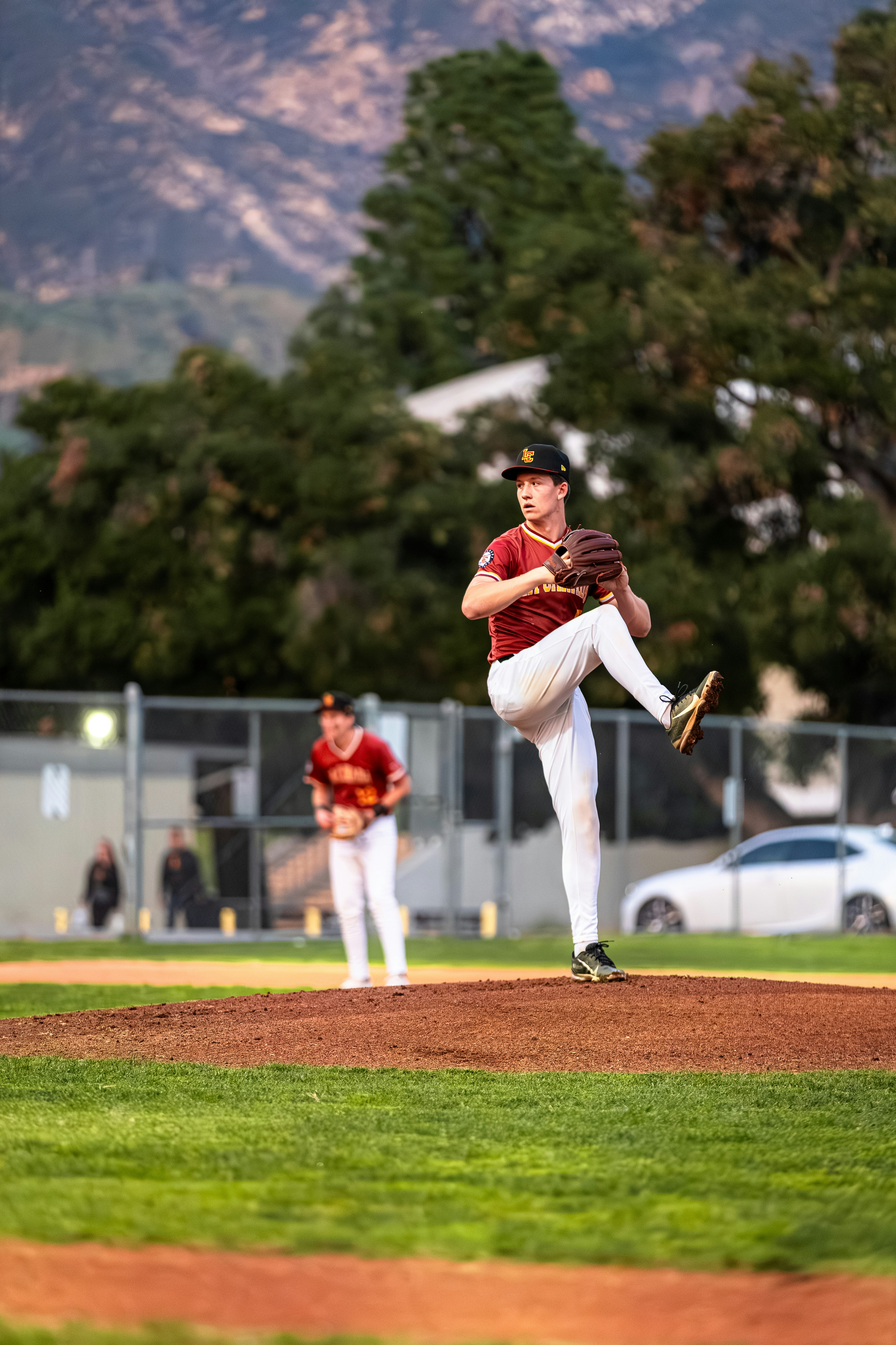 Baseball pitcher in uniform on the mound ready to throw.